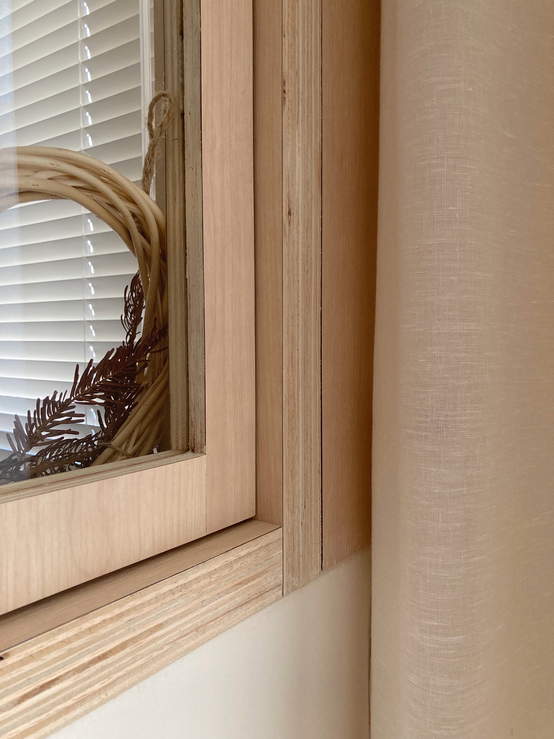 Choosing the right carpentry design and details  - Wooden window frame, natural wood paneling, light beige wall, window