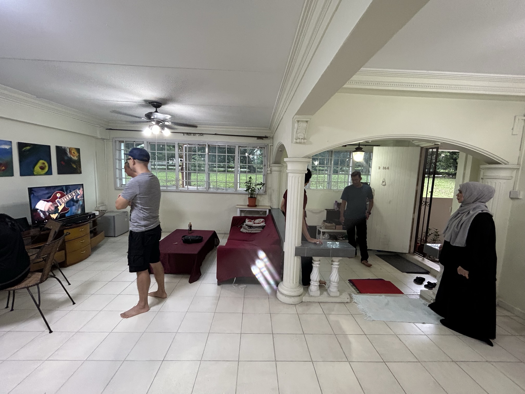 Entryway/ Balcony Transformation! - Living room, TV, man playing guitar, woman watching TV, room with white walls, ceiling