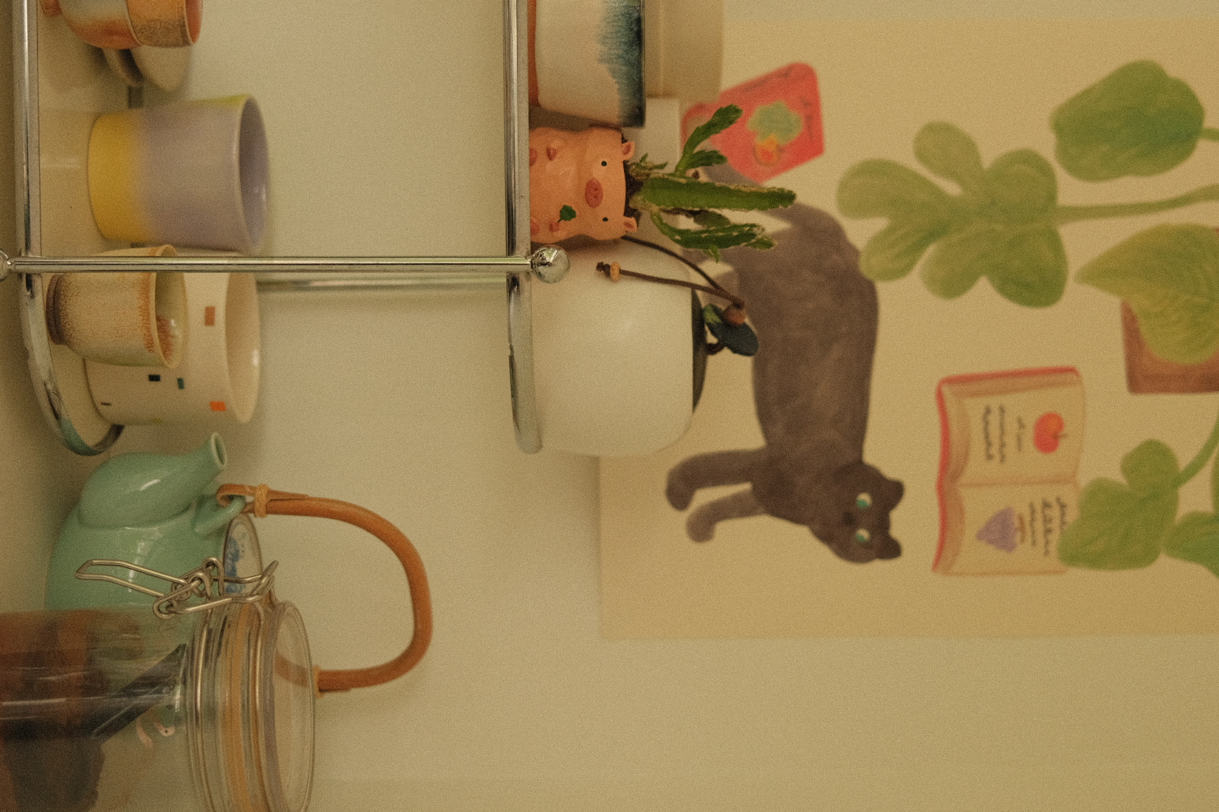 Welcome to our green sanctuary! - mugs, teapot, glass jar, colorful ceramic, wall-mounted rack, plant, black cat, green