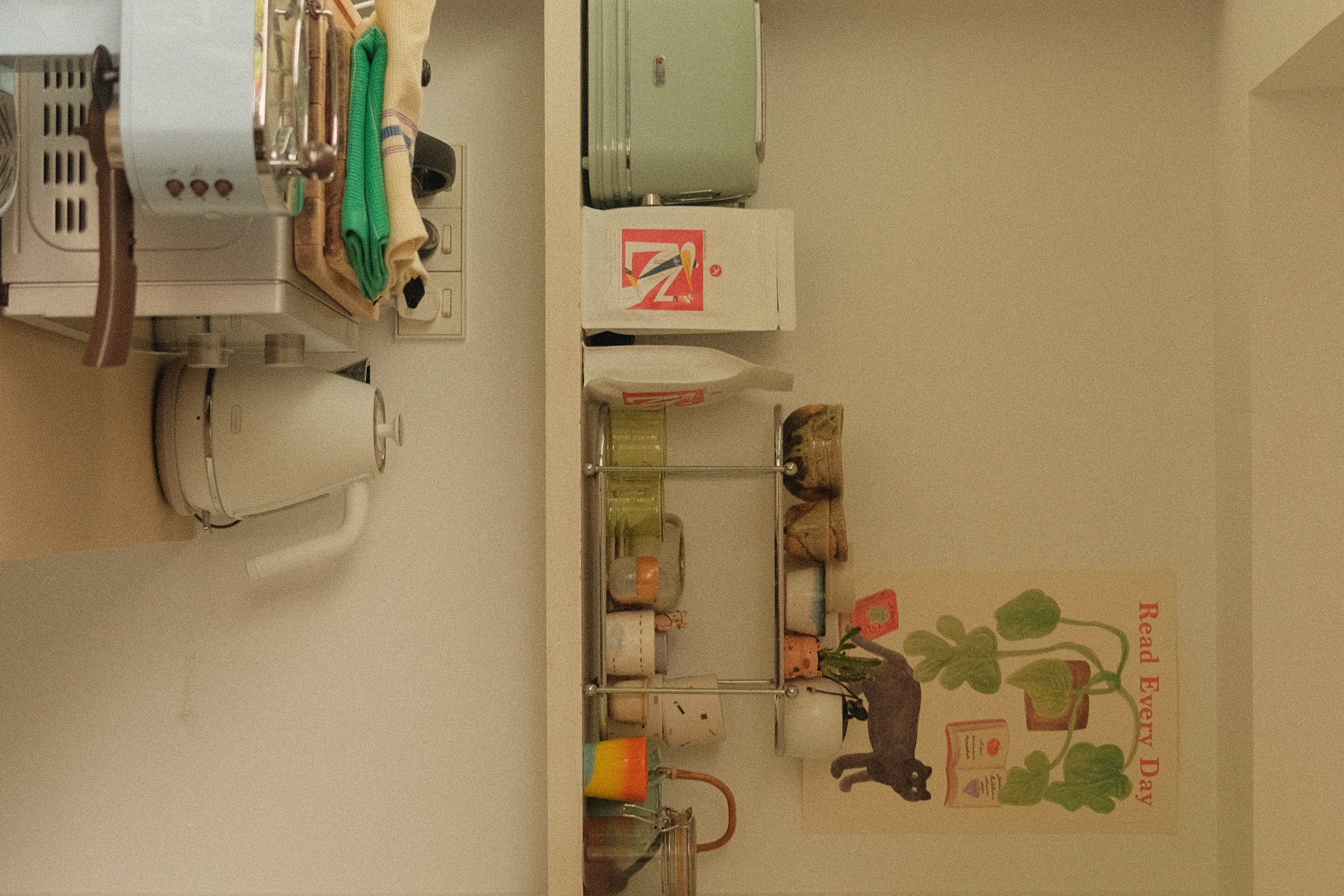 Open kitchen overlooking a green oasis! - coffee maker, kitchen appliances, toaster oven, green suitcase, white kettle, white