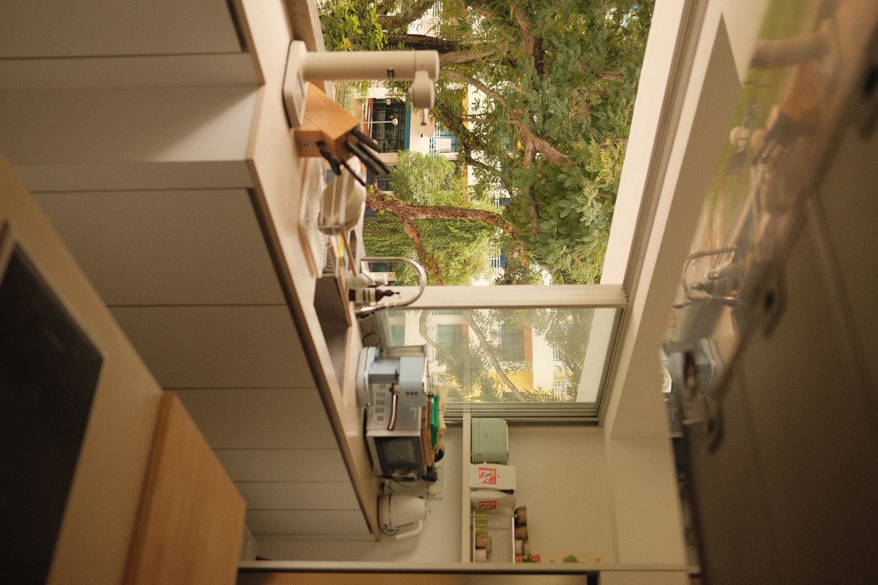 Open kitchen overlooking a green oasis! - kitchen, kitchen island, countertop, sink, stove, microwave, cabinets