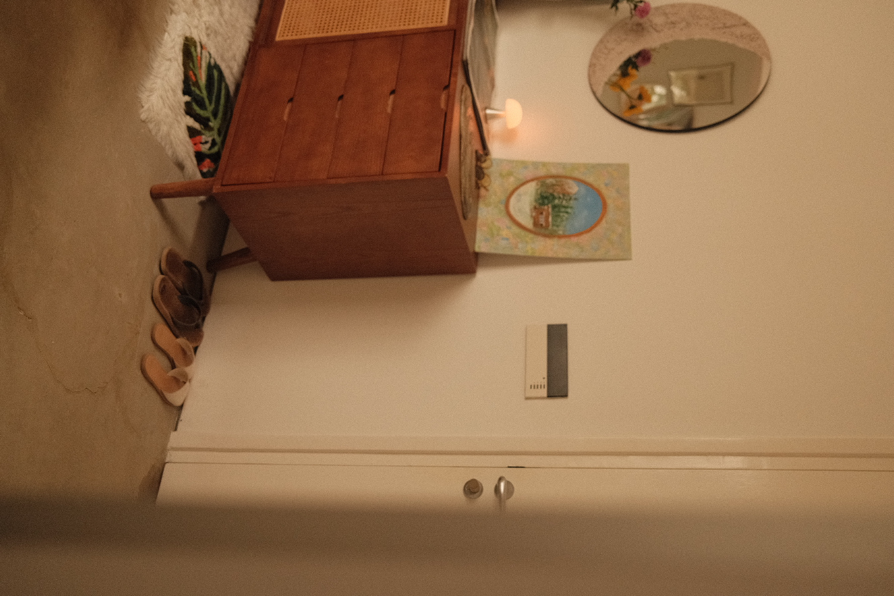 The tiny entryway to our heritage home - Wooden dresser, shoes, beige slippers, mirror, small round mirror, floral