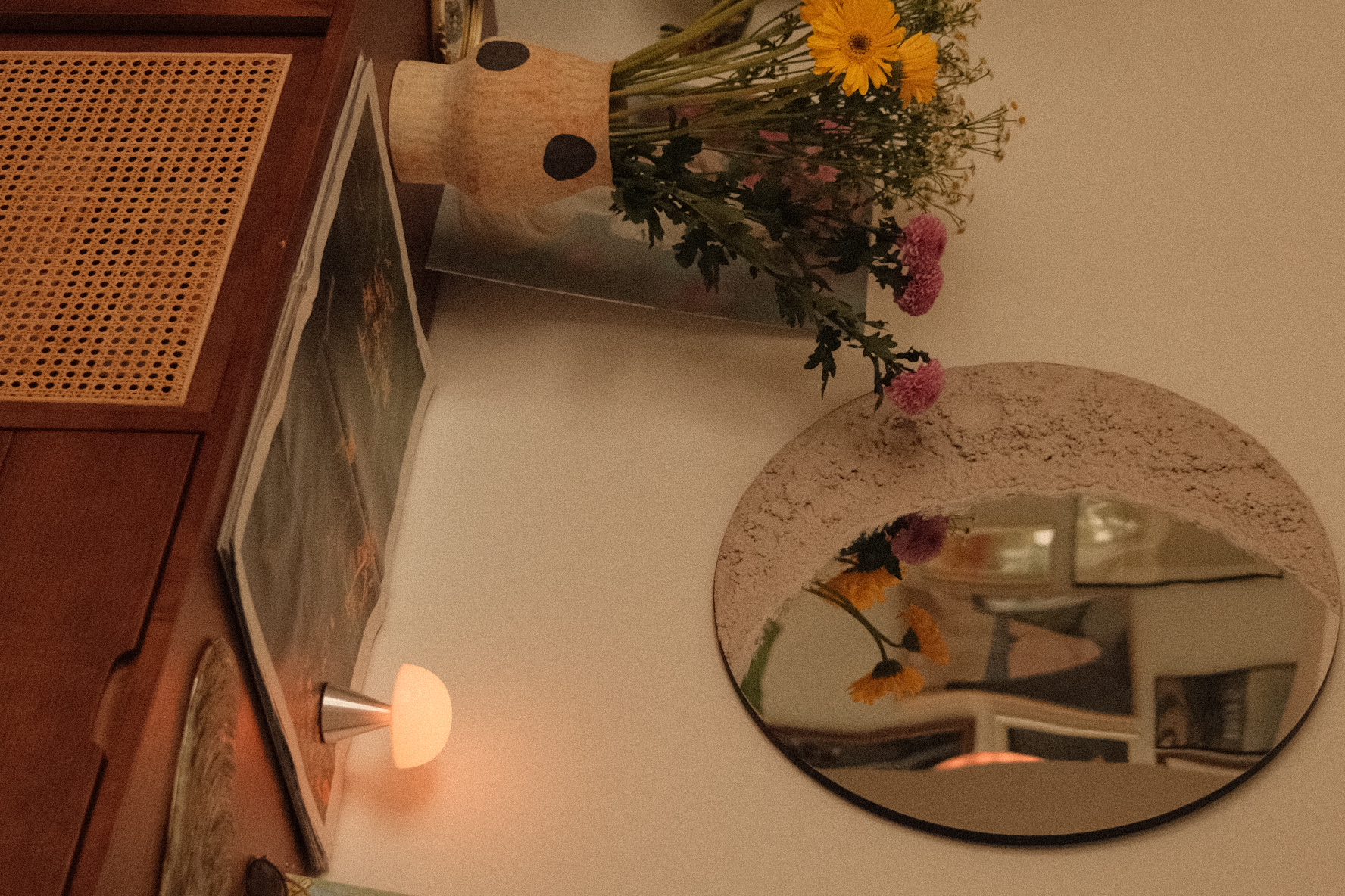 The tiny entryway to our heritage home - vase with flowers, mirror reflection, yellow flowers, pink flowers, decorative