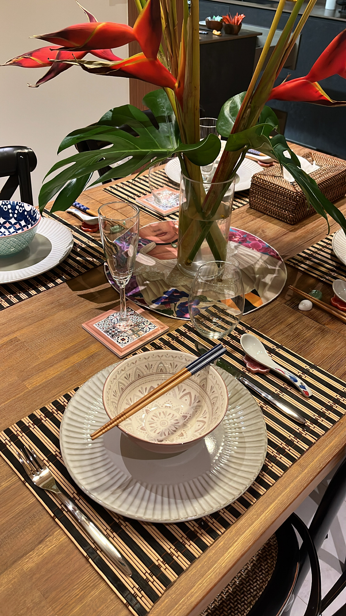 The Ultimate Hosting Guide - vibrant red flowers, elegant table setting, traditional Asian design, wooden dining table, woven