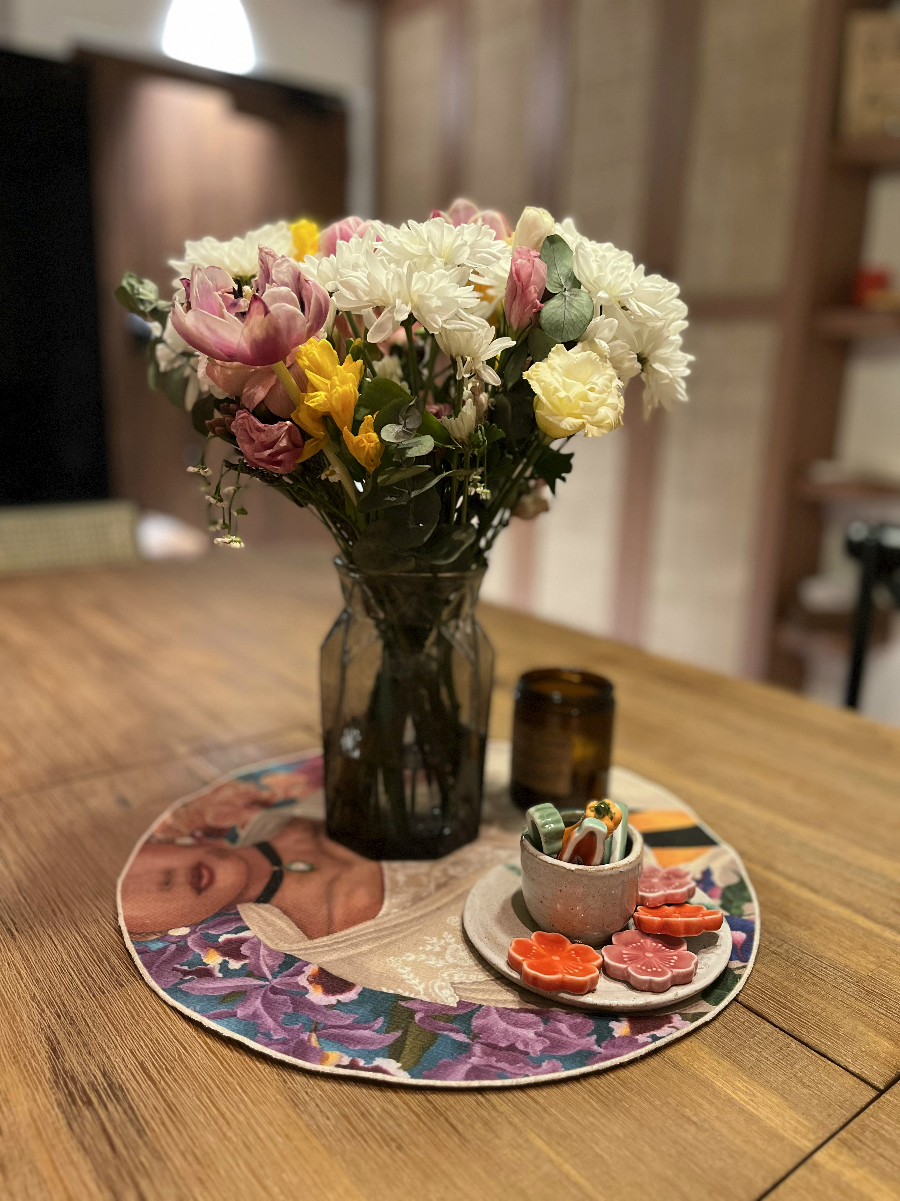The Ultimate Hosting Guide - vase with colorful flowers, table setting, floral arrangement, wooden table, decorative plate