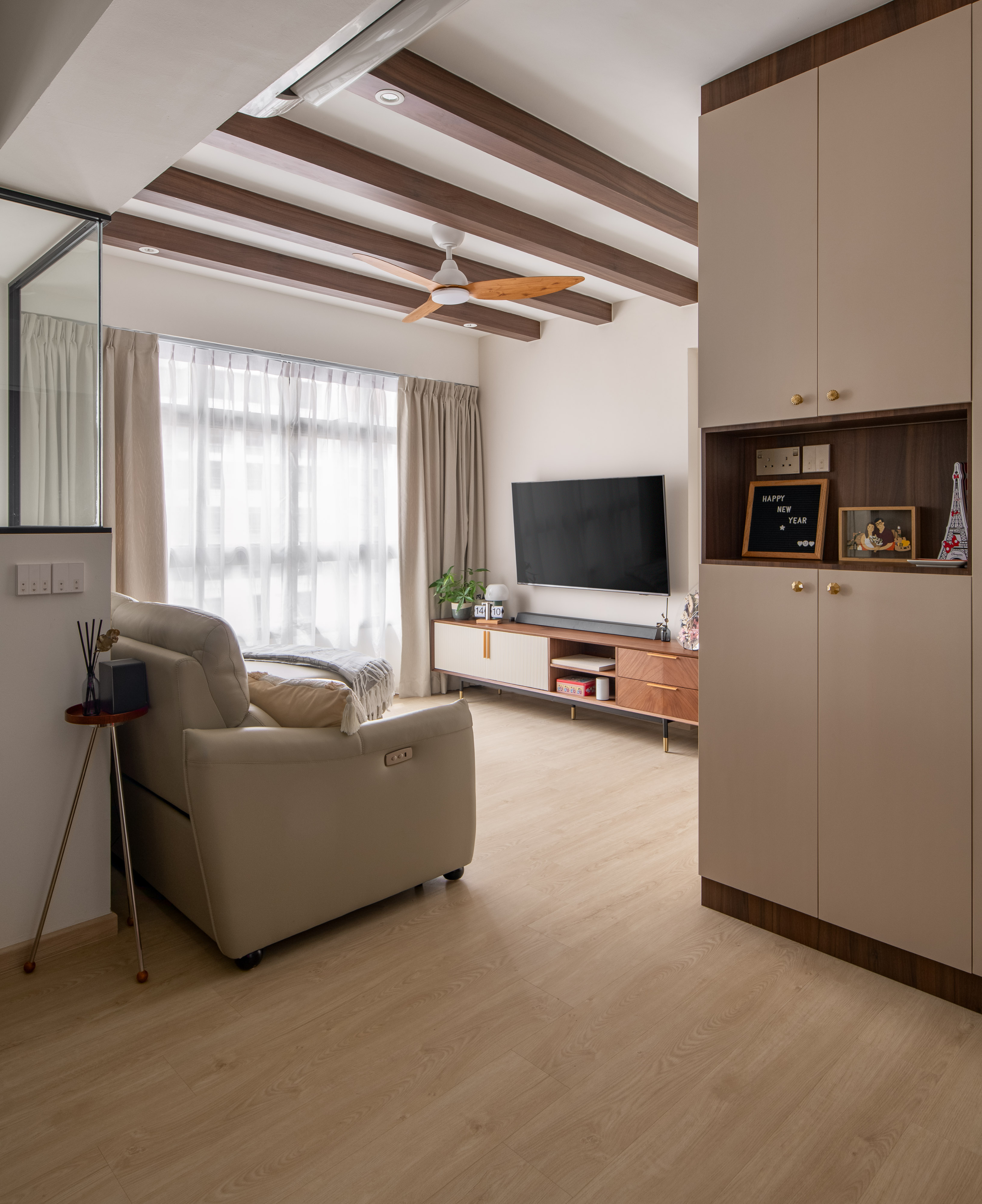 Entryway that welcomes you into our home - Modern living room with beige sofa, wooden floor, large window with sheer