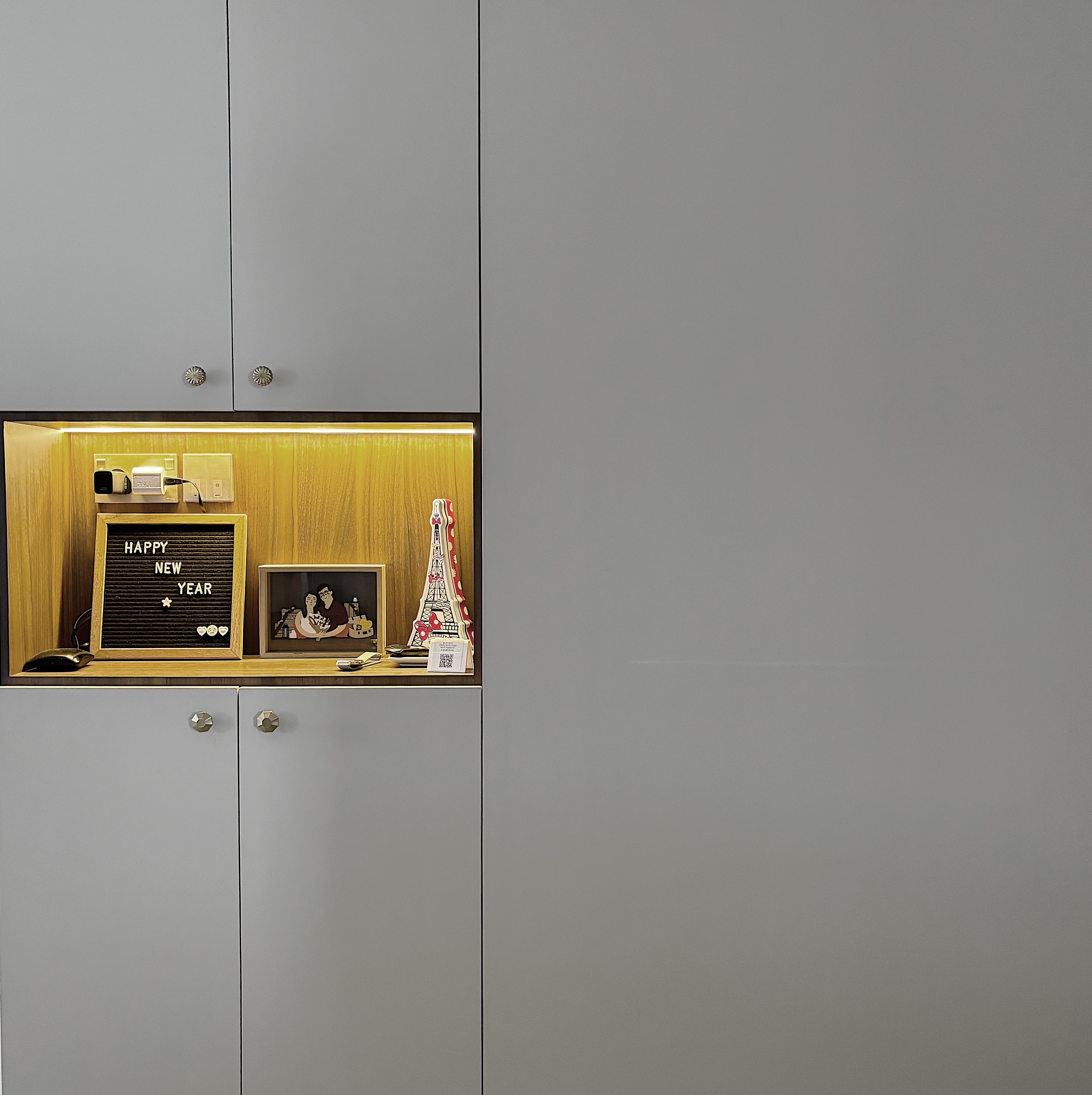 Entryway that welcomes you into our home - Cabinet with illuminated interior, wooden panel background, modern design, gray