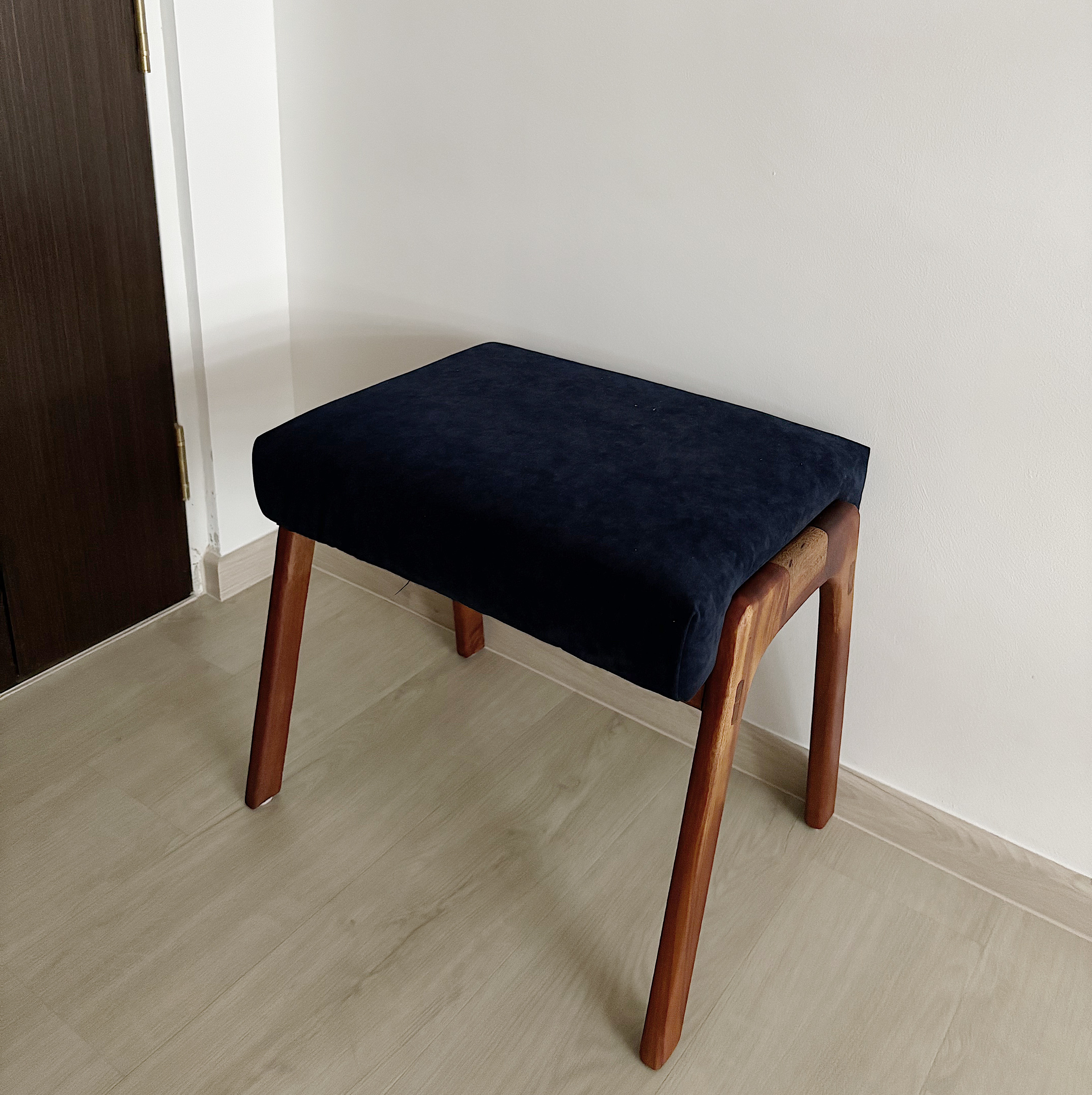Entryway that welcomes you into our home - Dark wooden bench, light wooden floor, minimalist design, dark blue cushion