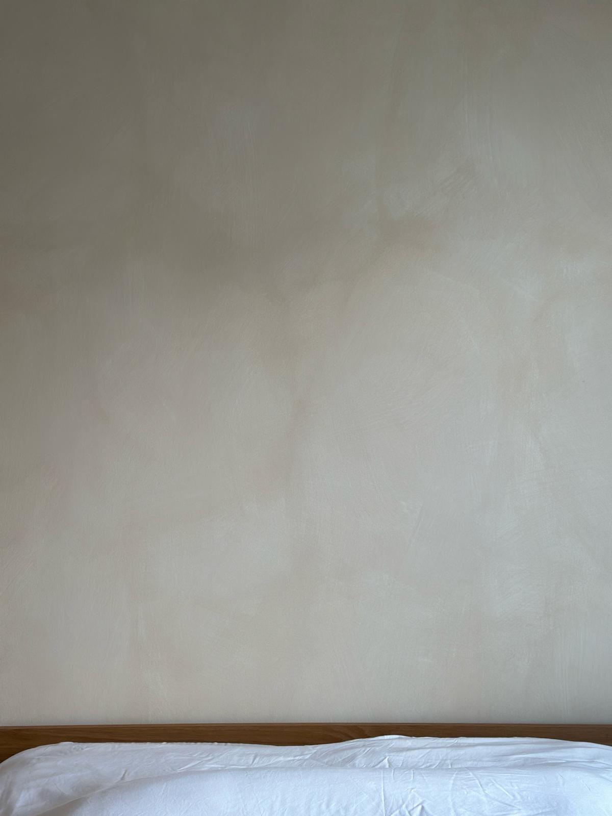 Japandi and wabi-sabi master bedroom  - Minimalistic bedroom with plain beige wall, White bedspread on a simple wooden