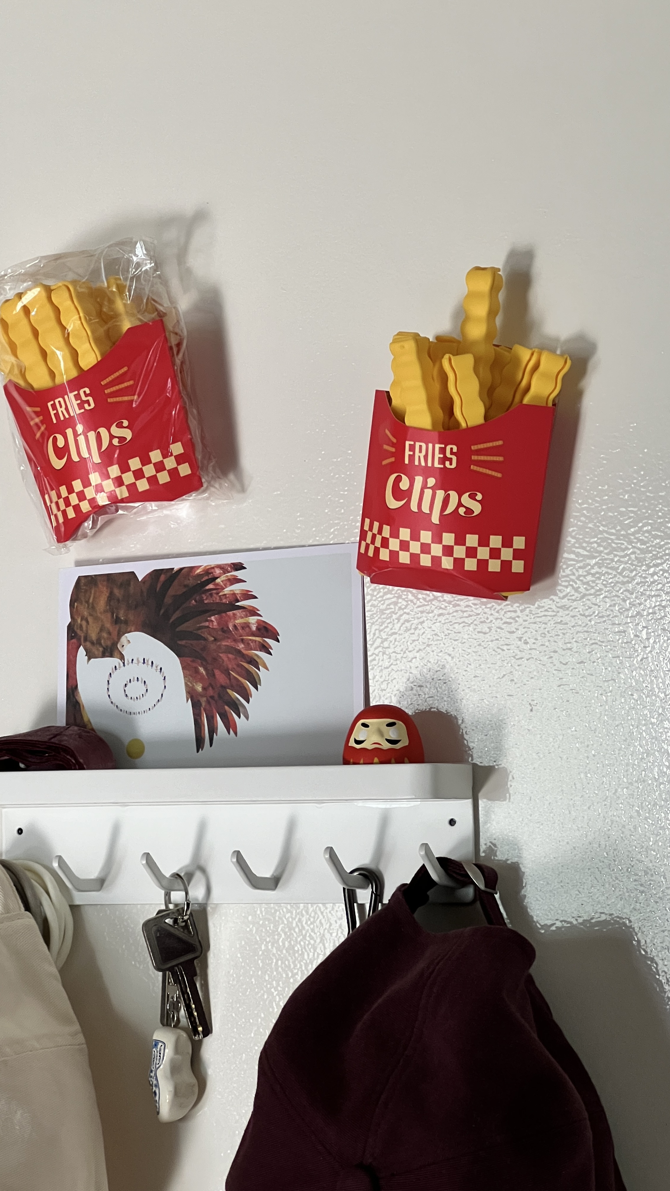 The entry way to wonders - Fries Clips, red packaging, yellow fries, hanging organizer, key holder, maroon hoodie, white