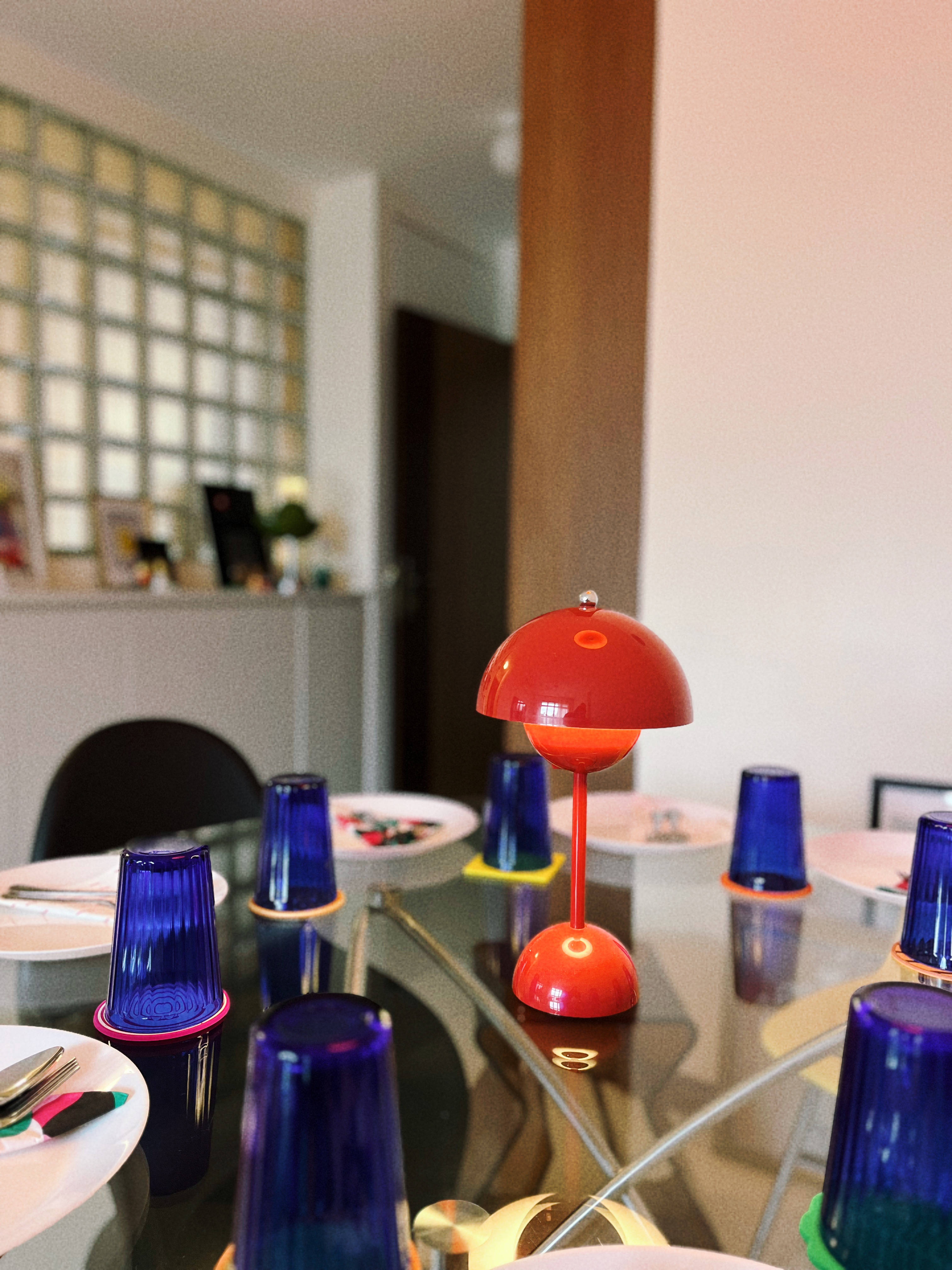 A retro and playful home - Modern dining table, colorful tableware, blue and red lamp, abstract art, geometric design