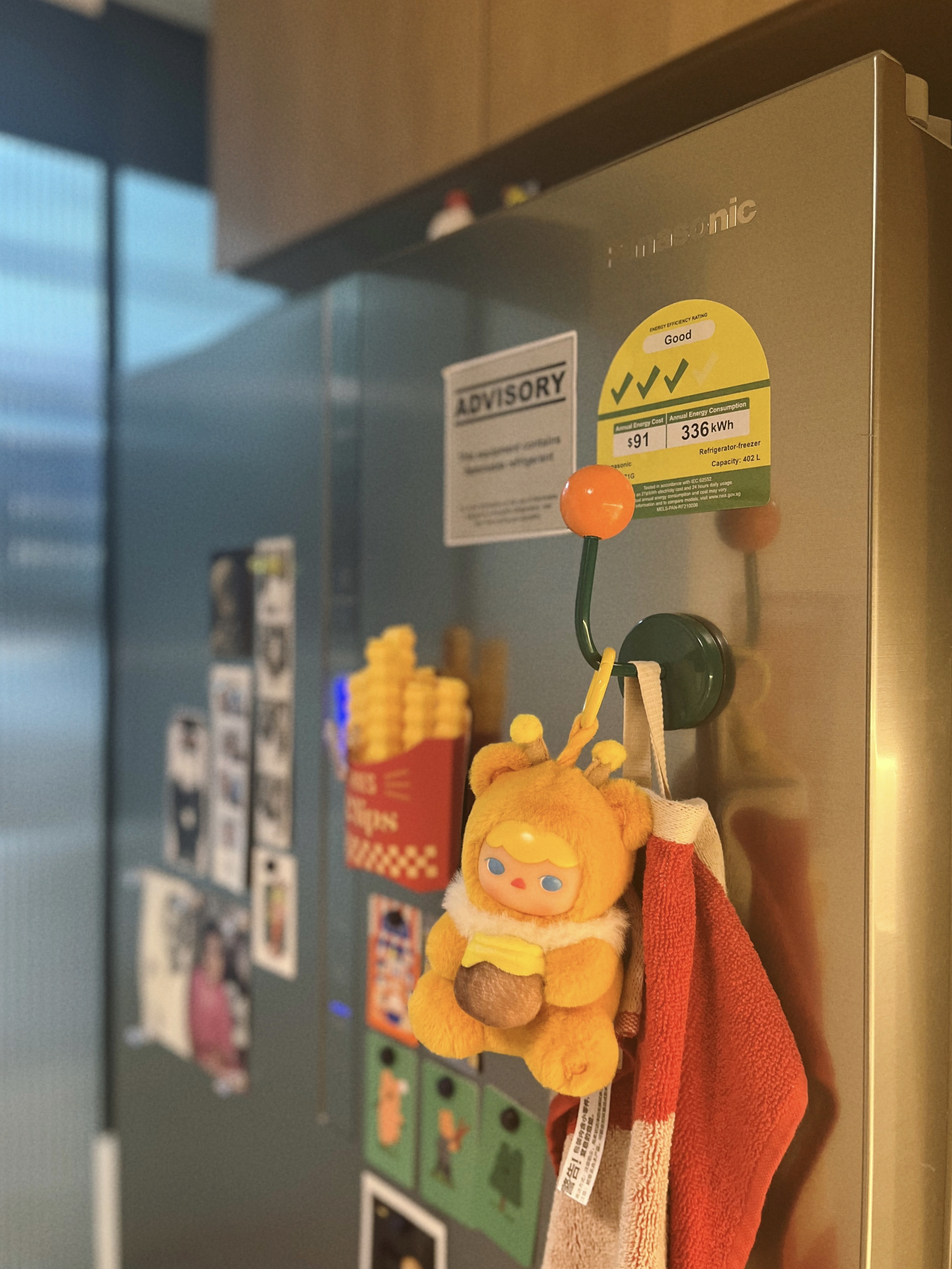 A retro and playful home - Refrigerator, toy, hanging, orange ball, yellow plush, "Good" energy efficiency sticker, annual