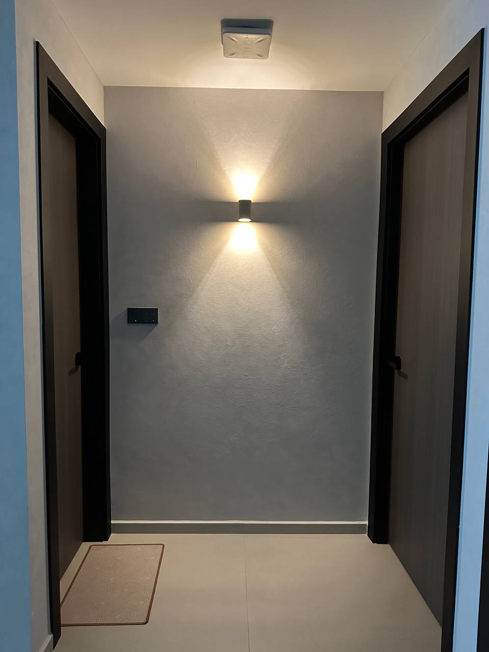 A modern minimalist inspired home  - Modern minimalist hallway, sleek black doors, soft ambient lighting, clean lines