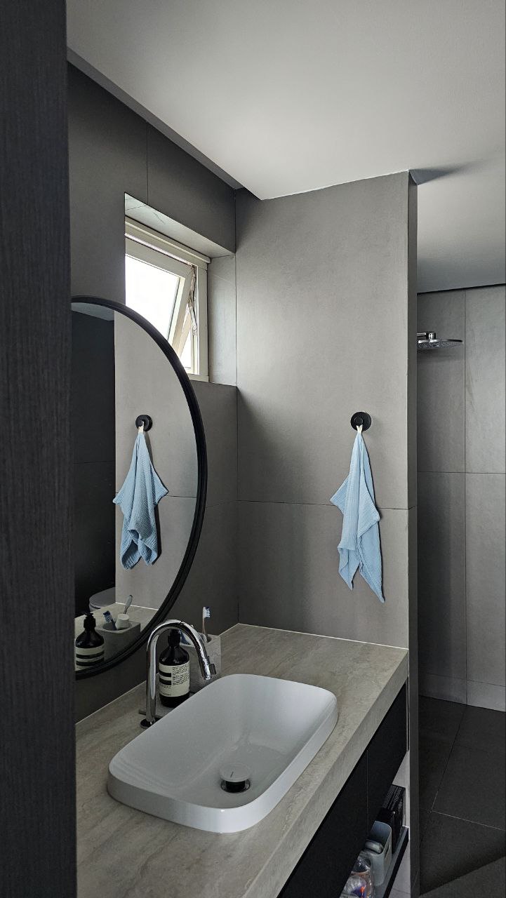 A modern minimalist inspired home  - modern bathroom, minimalist design, sleek vanity, round mirror, floating shelf, gray