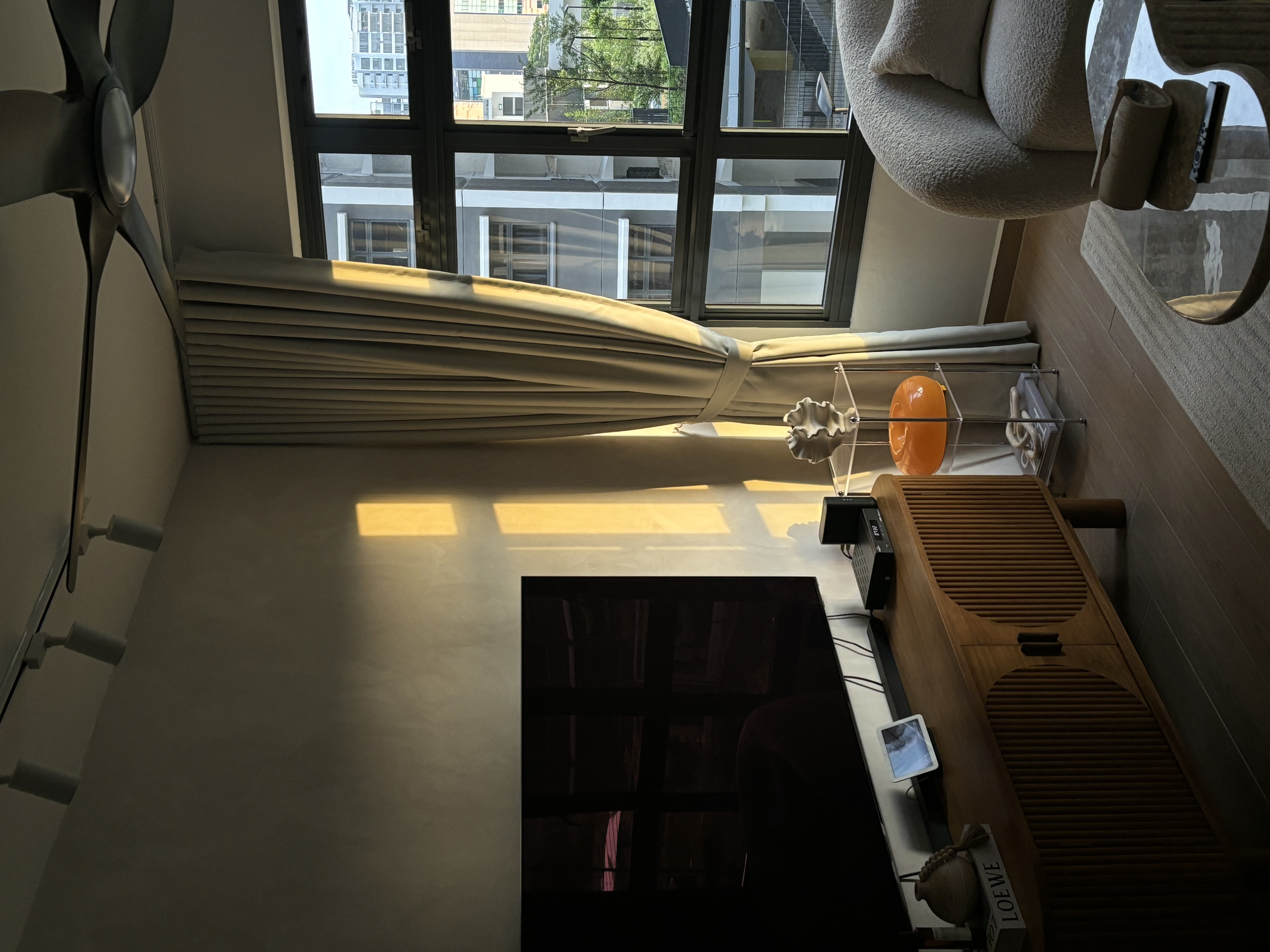 4-room Scandi Minimalist under 37k - sunlight streaming through large windows, modern ceiling fan, soft beige curtains