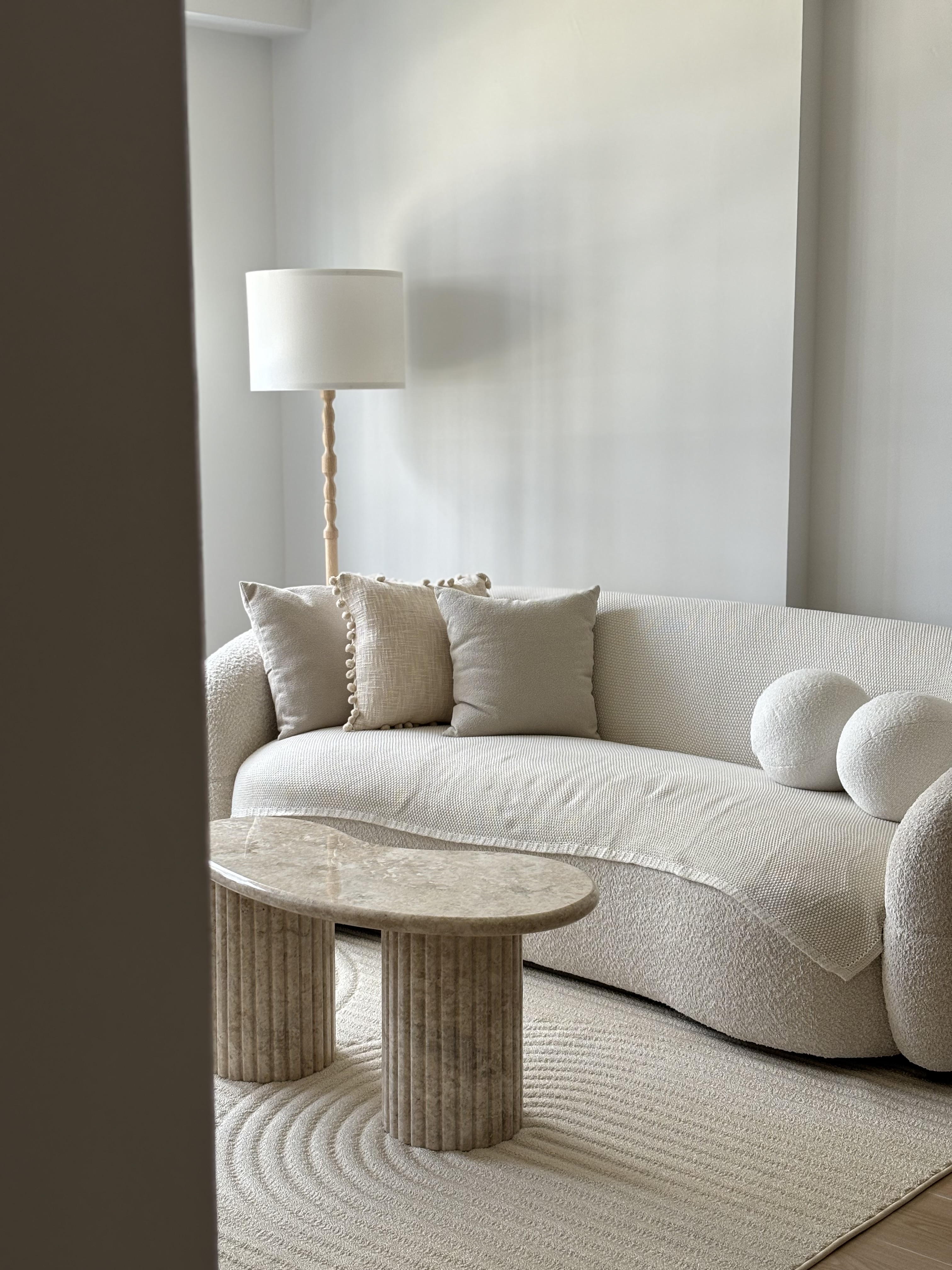 4-room Scandi Minimalist under 37k - Cream-colored, modern sofa with textured cushions, marble coffee table, minimalist