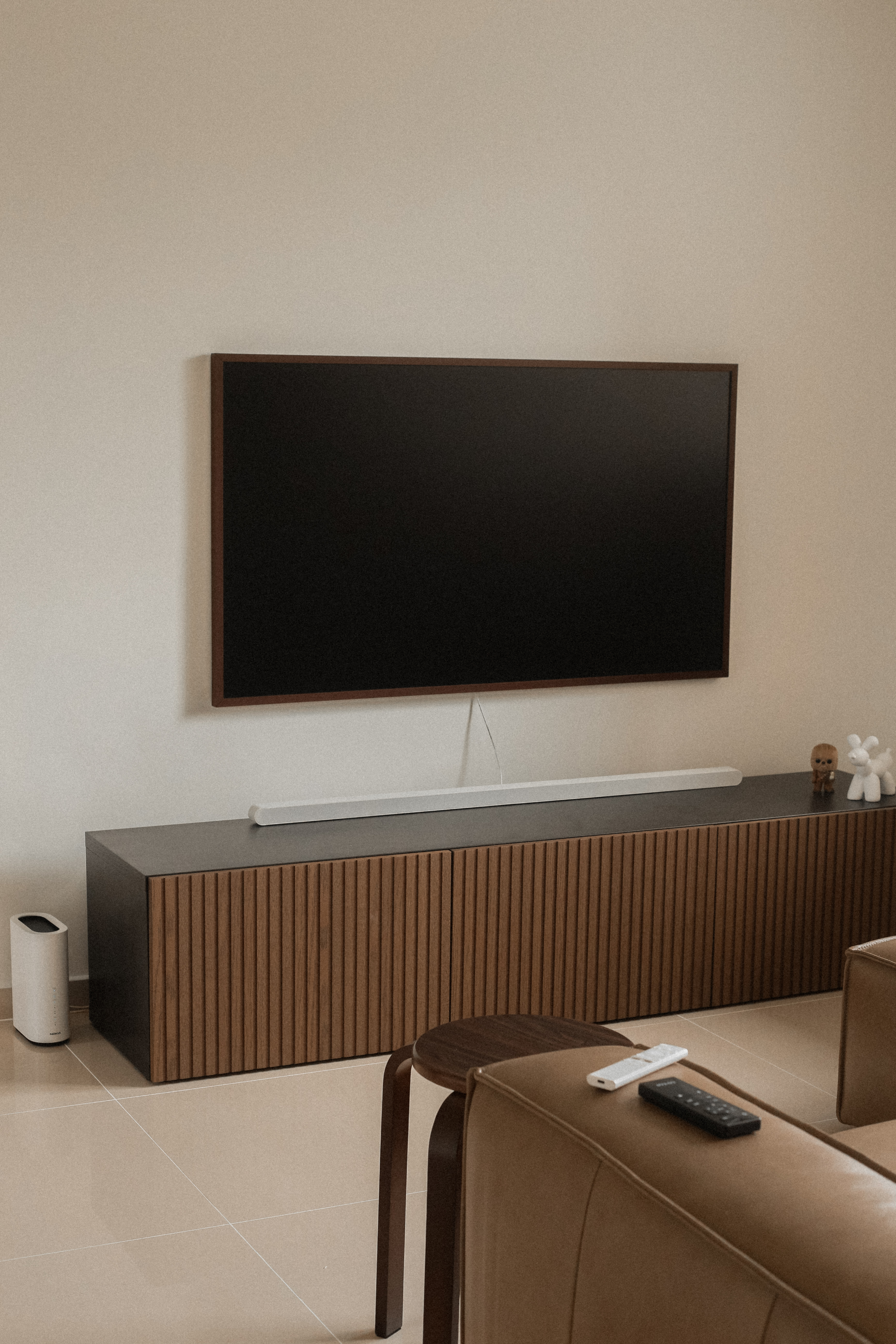 Welcome to our Littleroot House! - Modern living room, minimalist decor, large flat-screen TV, sleek console, wooden