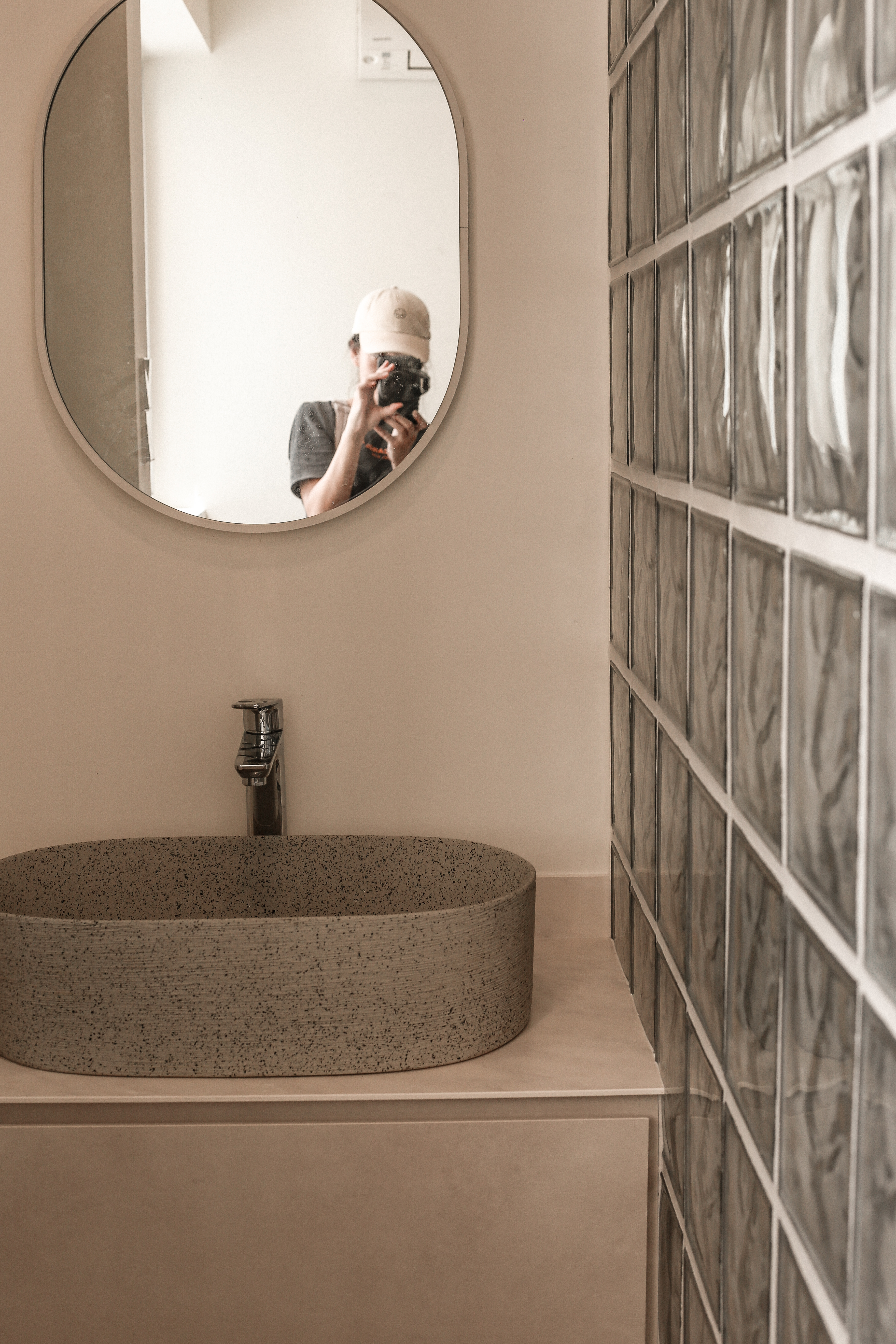 Welcome to our Littleroot House! - Mirror reflection, person taking photo, round mirror, white wall, bathroom vanity