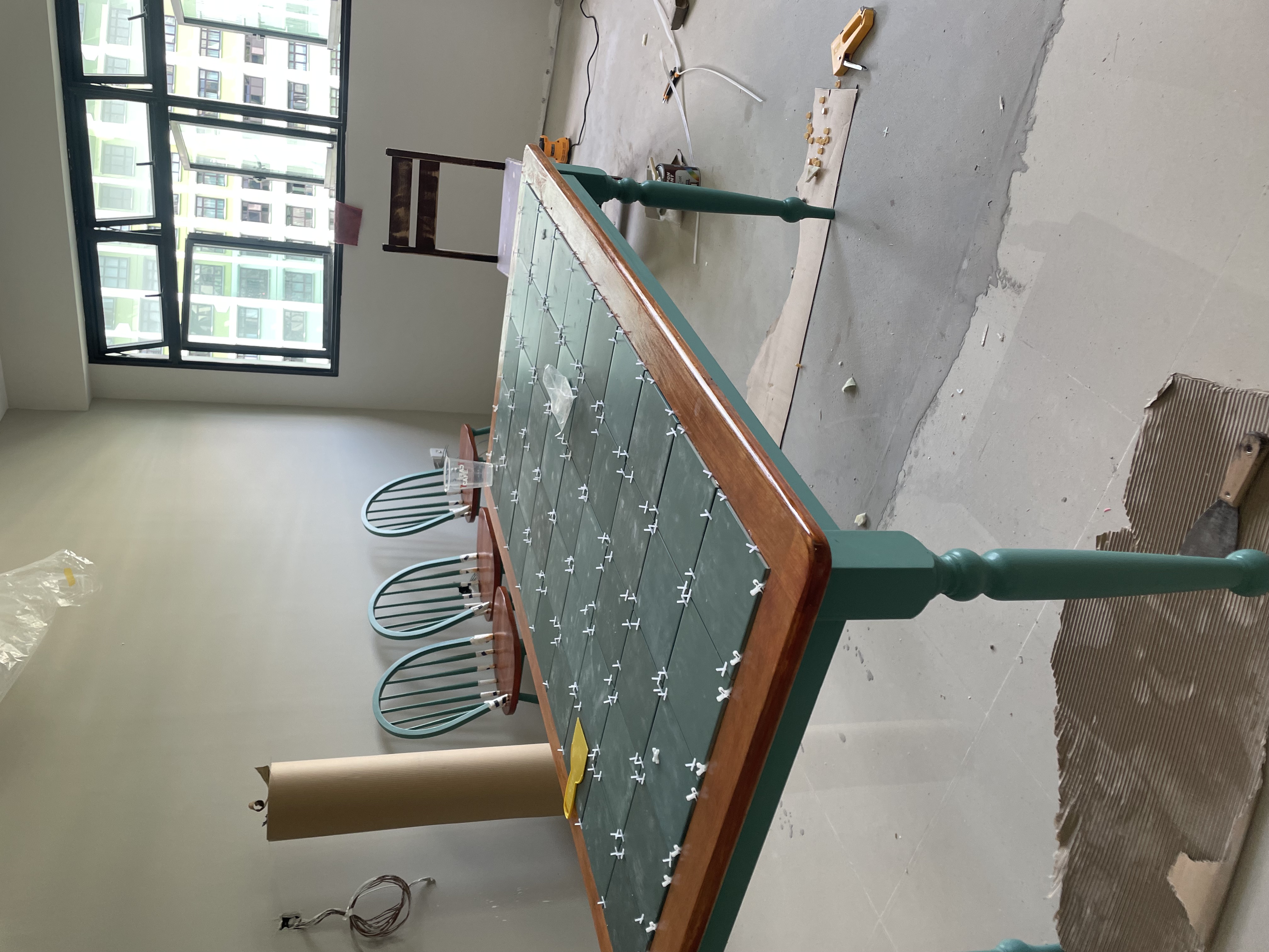 Meet our most "talked about" piece of furniture 👀 - green chair, construction site, wooden frame, cardboard floor, plastic