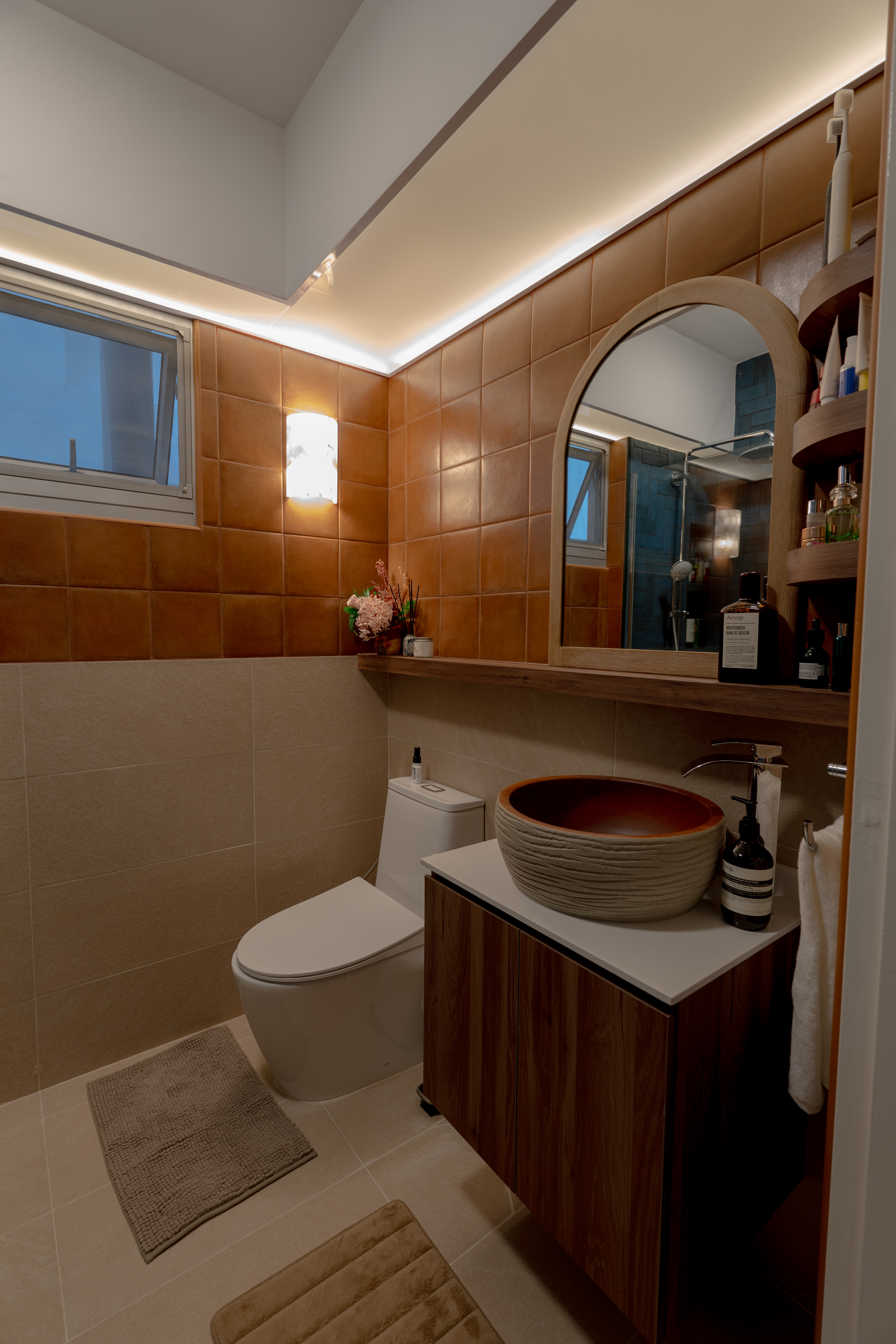 One Resort Villa Style, Two Iconic Bathrooms - Modern bathroom with brown tiles, beige walls, wooden vanity, large oval sink