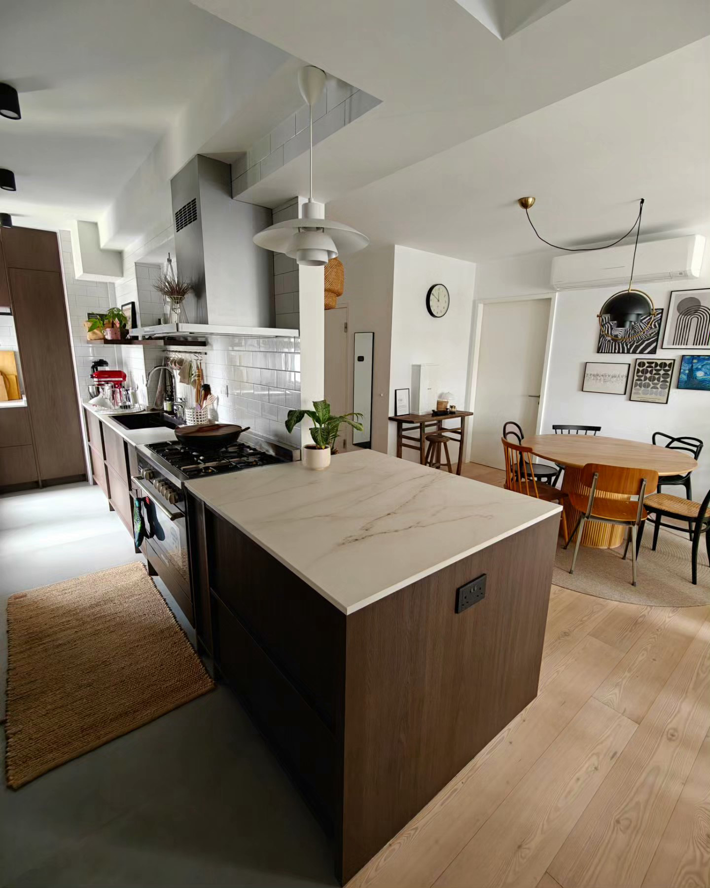 A 3-Gen Scandinavian Home - Modern kitchen with marble countertop, wooden cabinets, white tiled backsplash, built-in oven