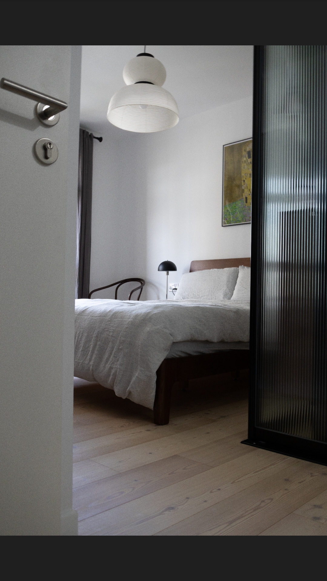 A 3-Gen Scandinavian Home - modern bedroom, minimalist design, cozy atmosphere, wooden flooring, white bedding, black lamp