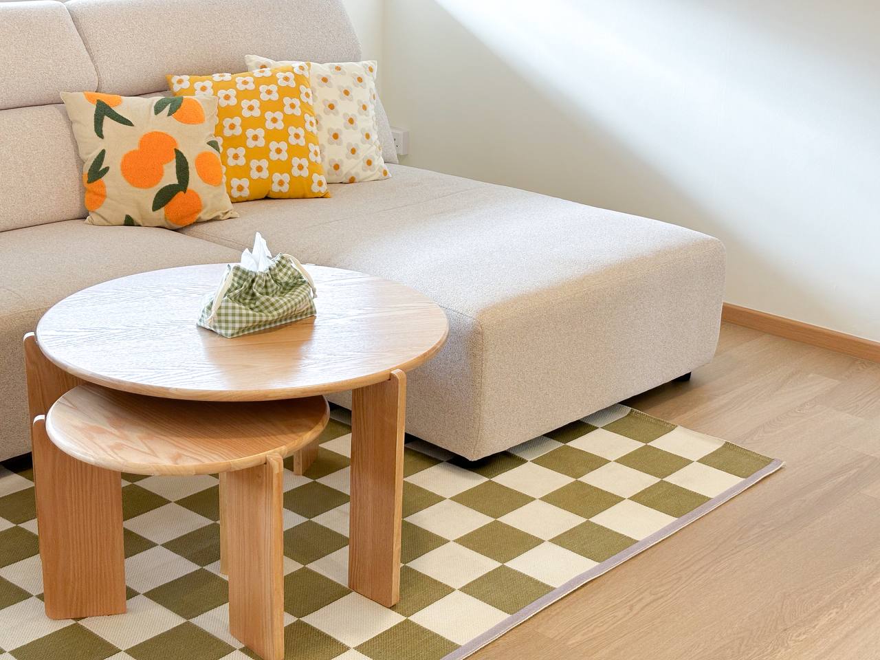 He wants it minimal, she wants it cute - Modern living room, cozy seating, beige sofa, orange floral pillow, yellow flower