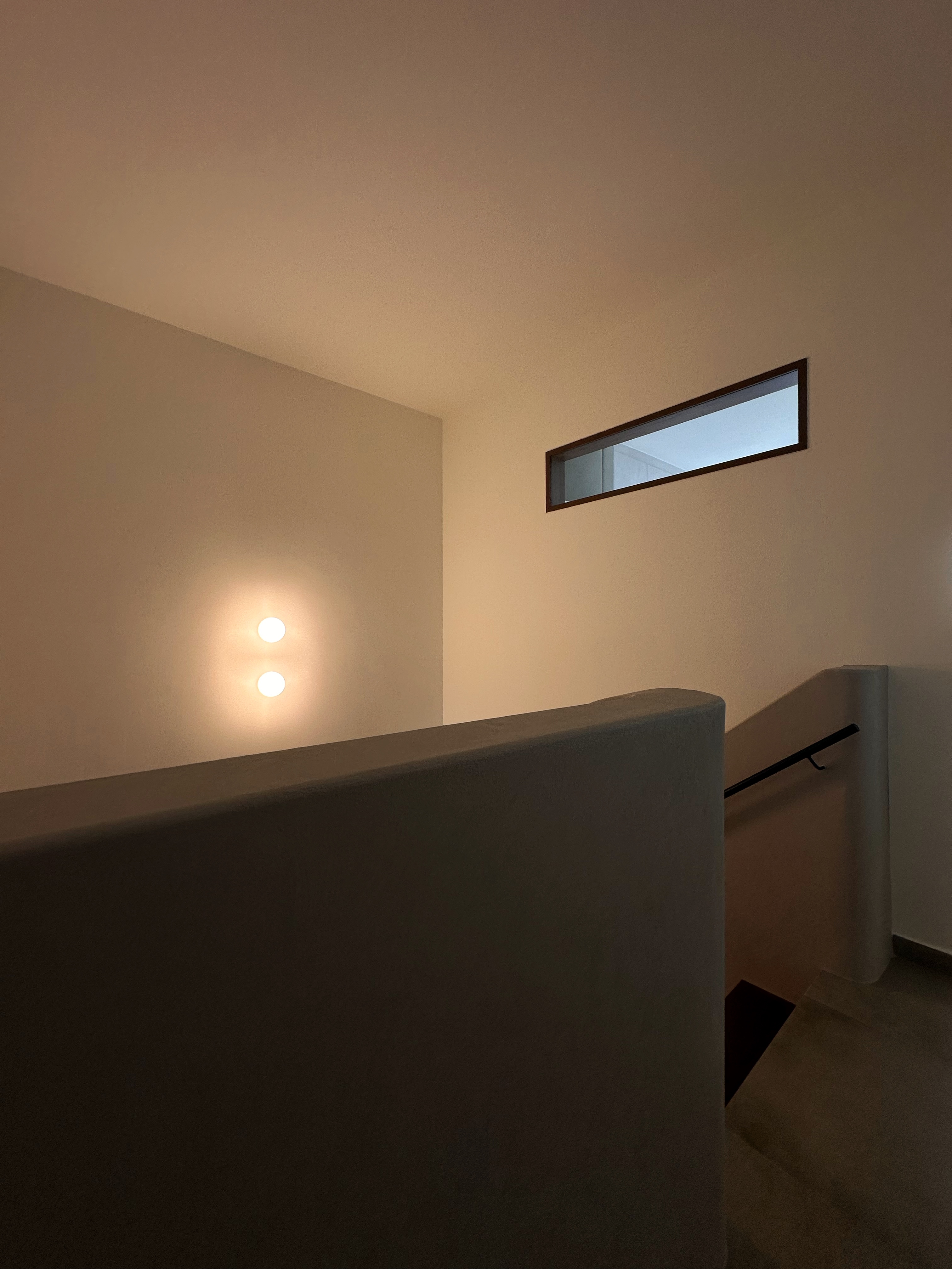 When Industrial meets Wabi-Sabi details within 1593sqft. - Modern minimalist interior, soft lighting, sleek wall, recessed