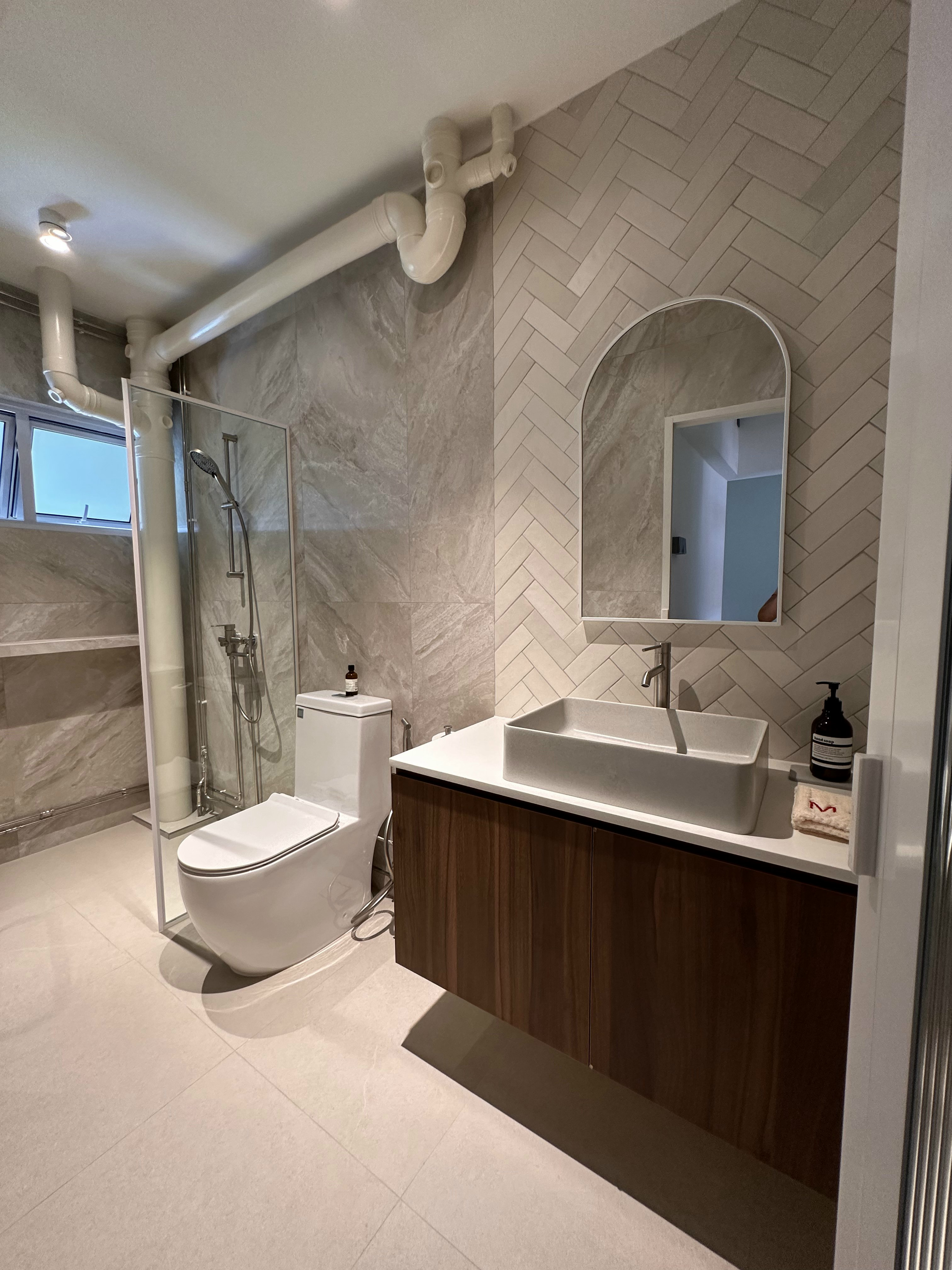When Industrial meets Wabi-Sabi details within 1593sqft. - Modern bathroom with sleek design, white toilet, glass shower