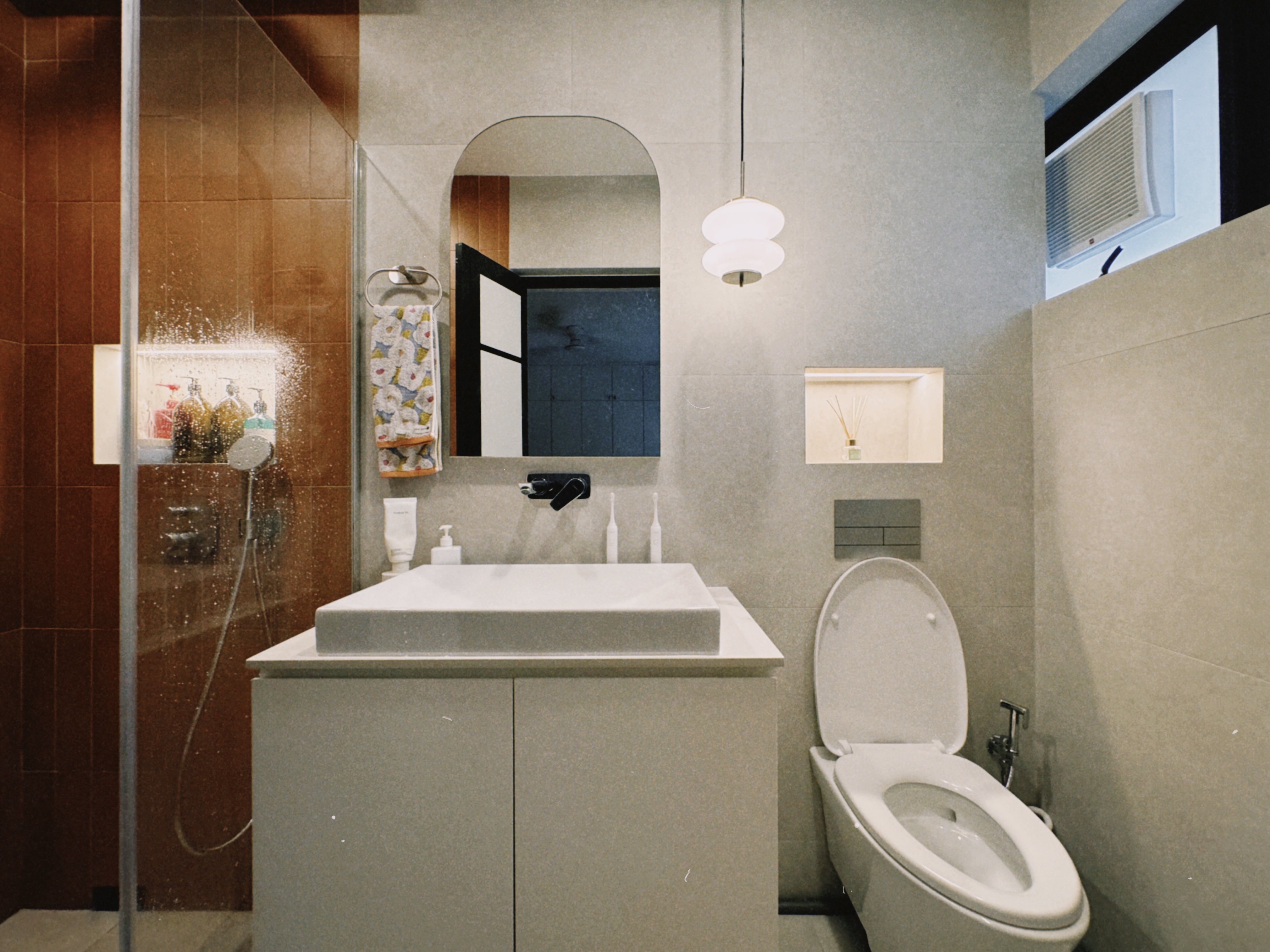 Before & After: Our 5-Room Resale Makeover - Modern bathroom with sleek design, beige and brown tiles, glass shower