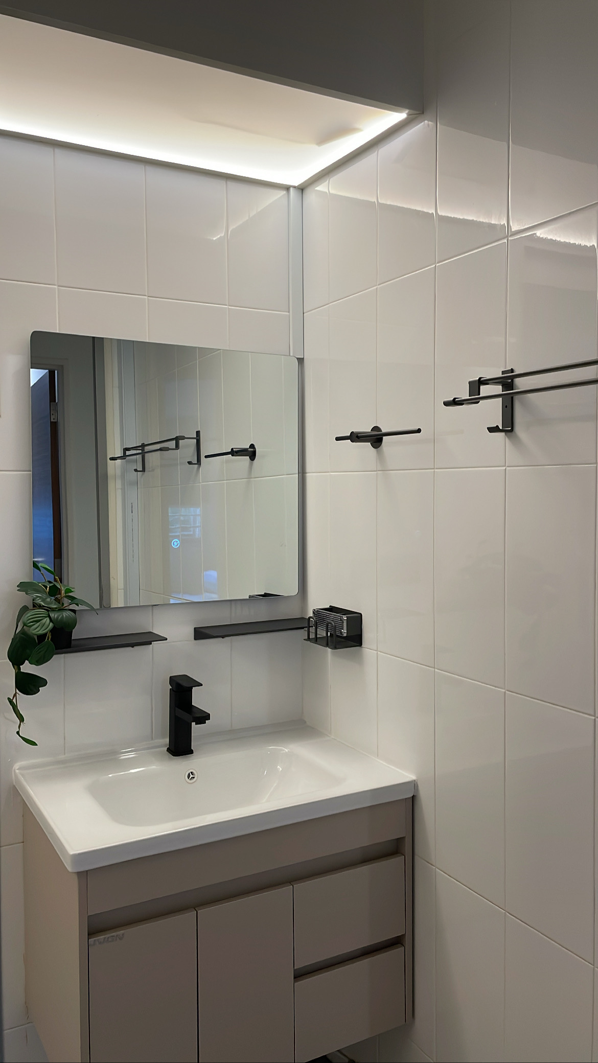 Our cosy crib filled with rattan-wooden accent pieces  - White tiled bathroom vanity, modern faucet, sleek black handles