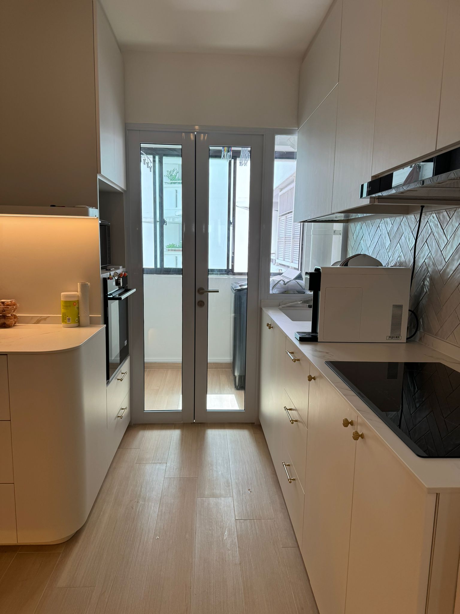 Flat white and gold modern minimalist 4rm resale HDB - Modern kitchen with sleek white cabinets, minimalist design, light