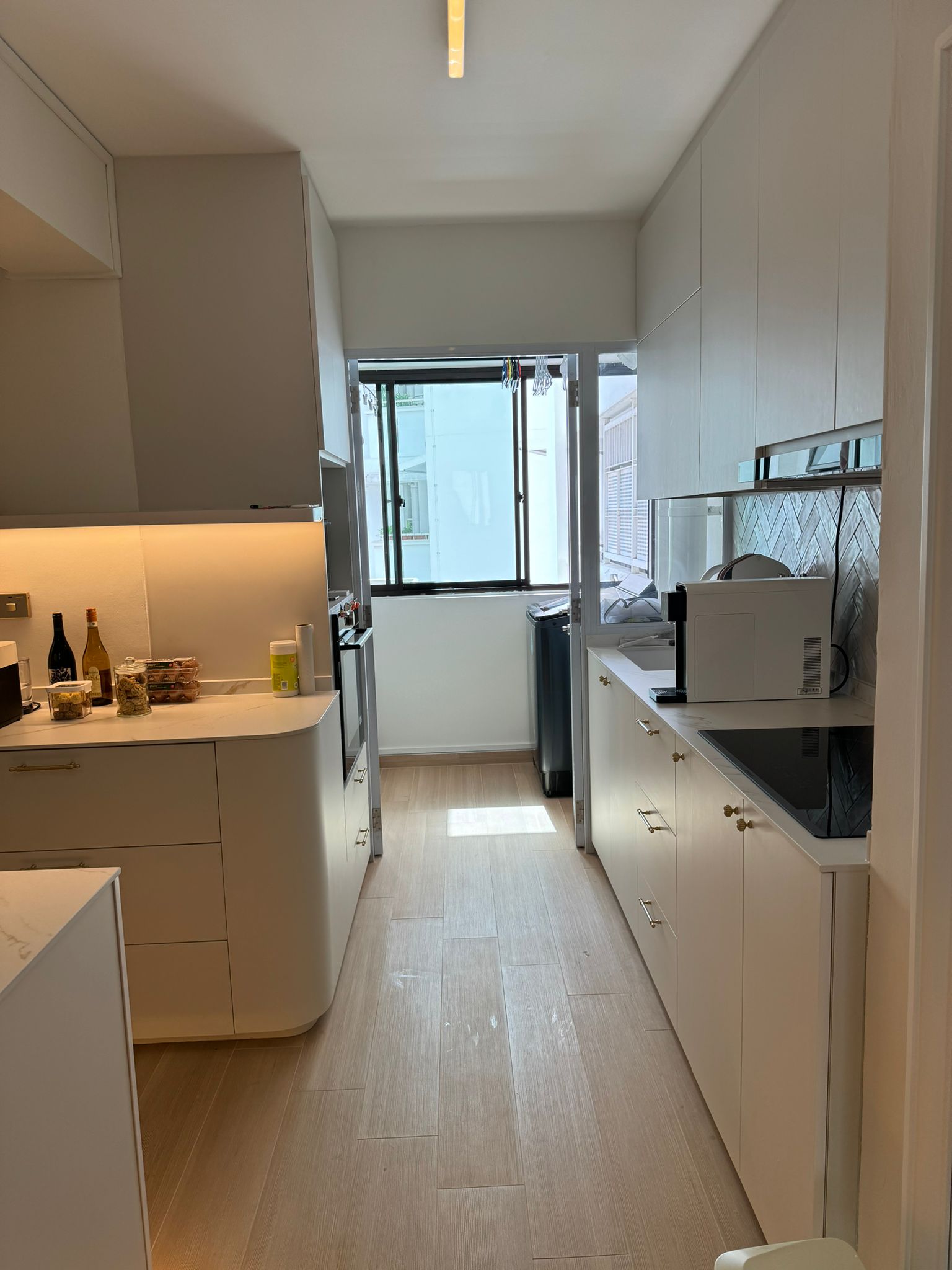 Flat white and gold modern minimalist 4rm resale HDB - Modern kitchen with white cabinetry, light wooden flooring, sleek