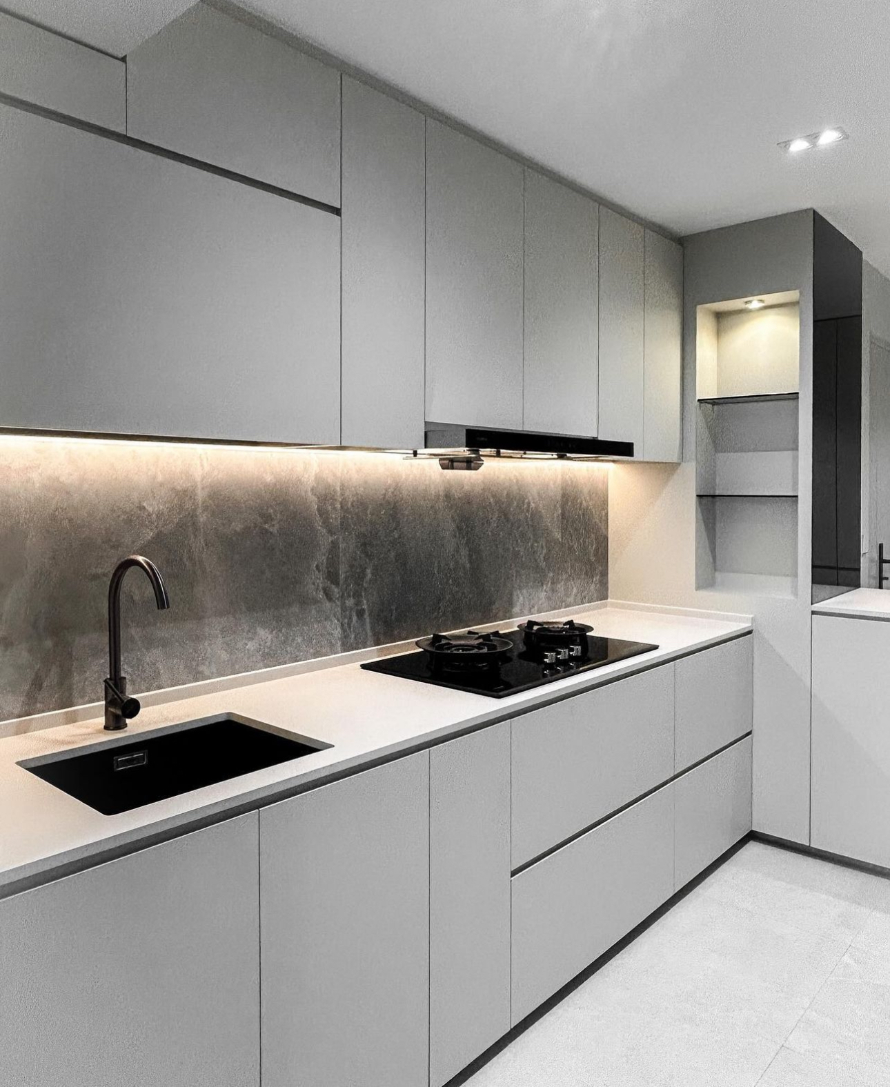 Unveiling The Littlestarry Loft - Grey kitchen cabinetry, sleek backsplash, black countertop, modern sink, under-cabinet