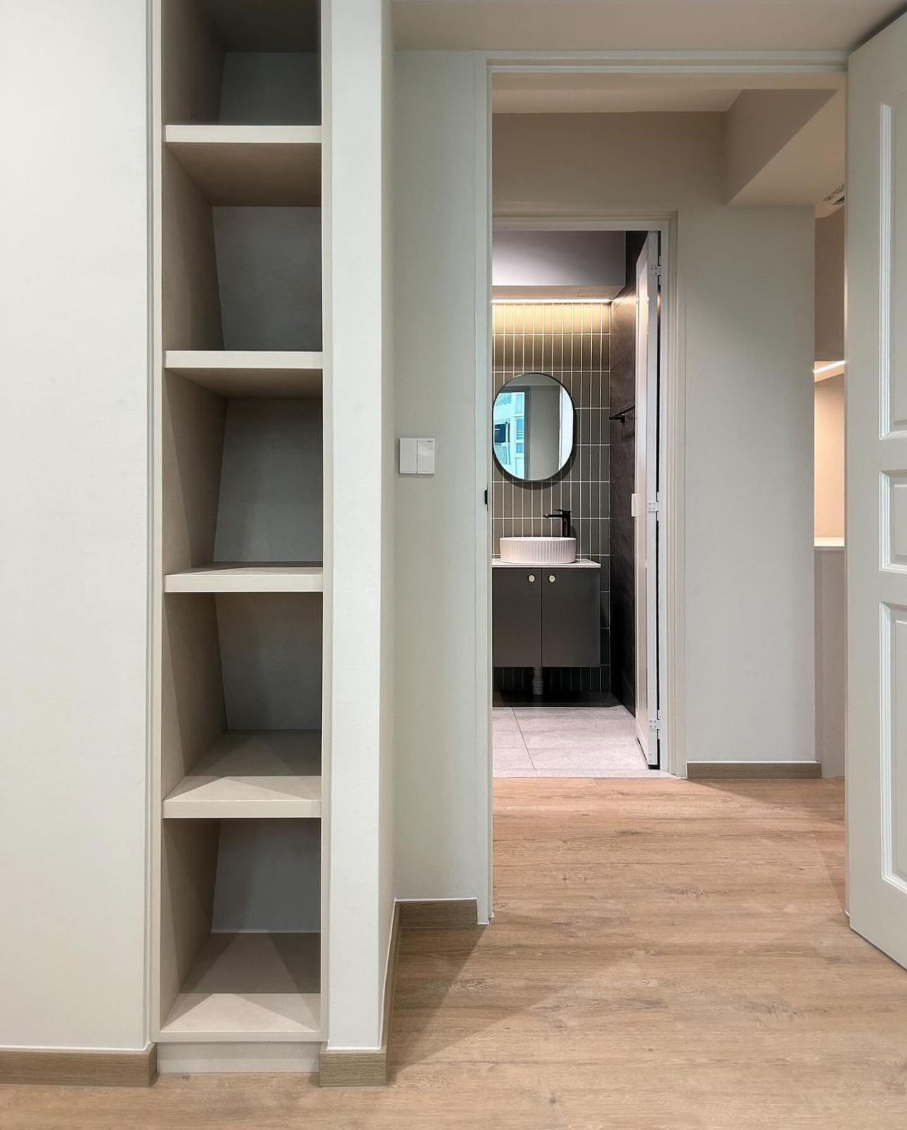 Unveiling The Littlestarry Loft - Minimalist shelving unit, open doorway, modern bathroom, floating vanity, circular mirror