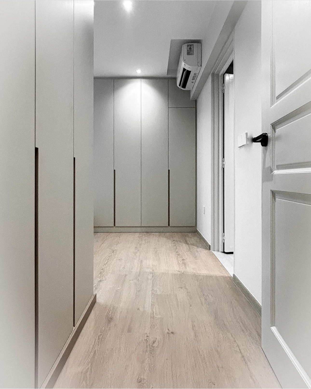 Unveiling The Littlestarry Loft - Light wood laminate flooring, modern minimalist design, sleek white cabinets, built-in