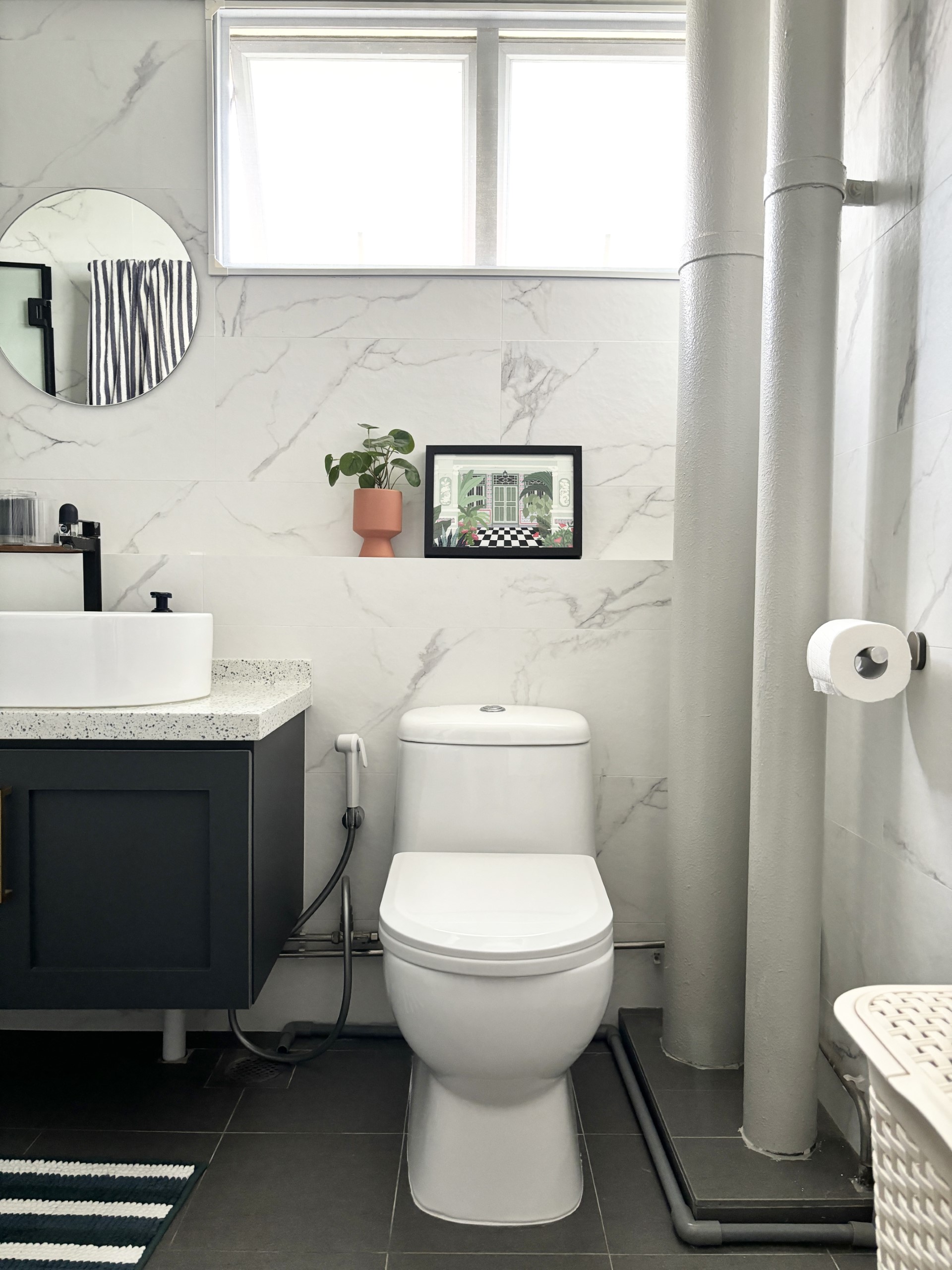 Warm & Cosy HDB Maisonette - White modern bathroom with marble accents, black and white striped towel, black and white