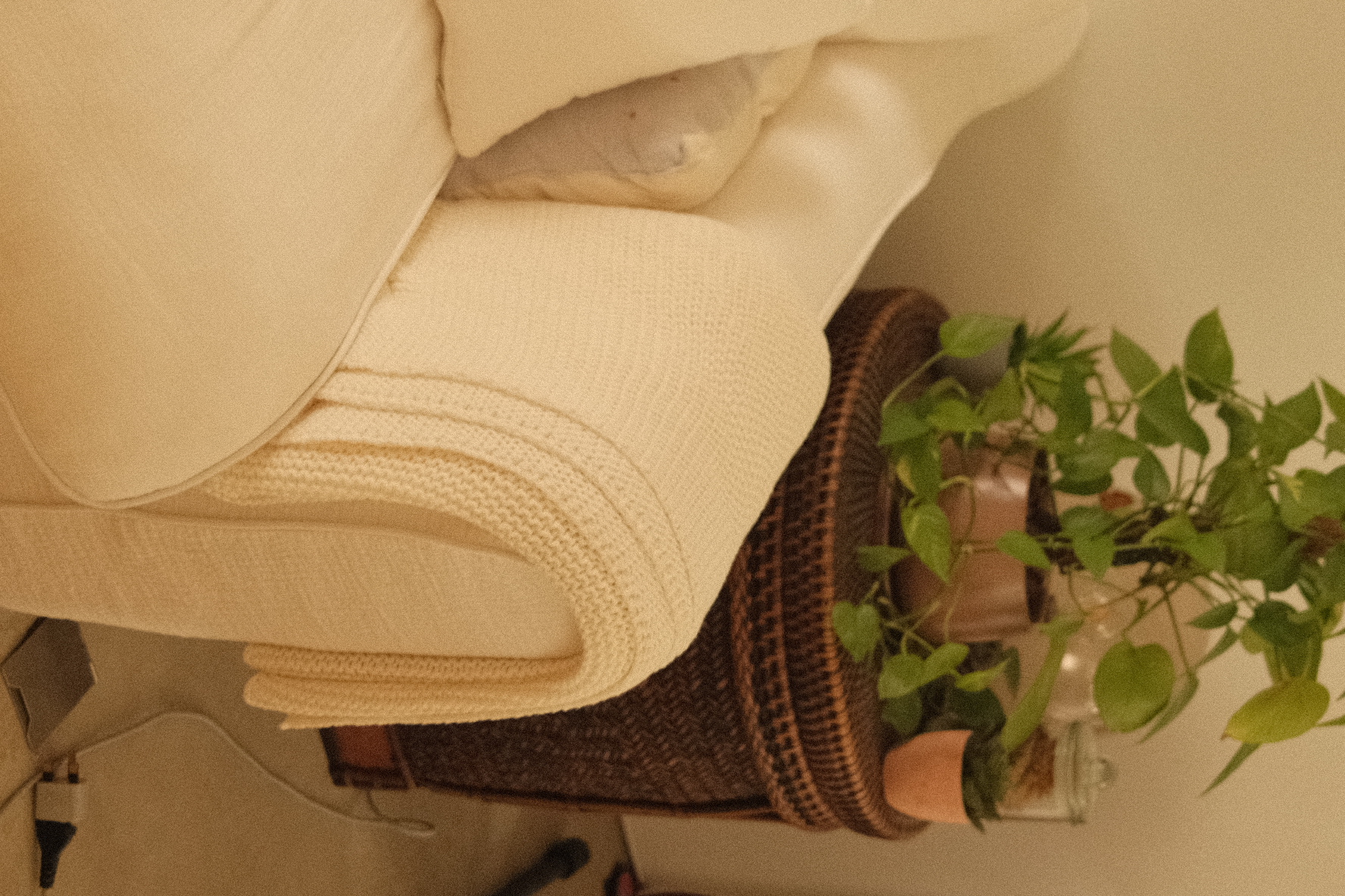 Our cozy corner in an eclectic home - Soft, cream-colored throw blankets, neatly folded, stacked, cozy living room, warm