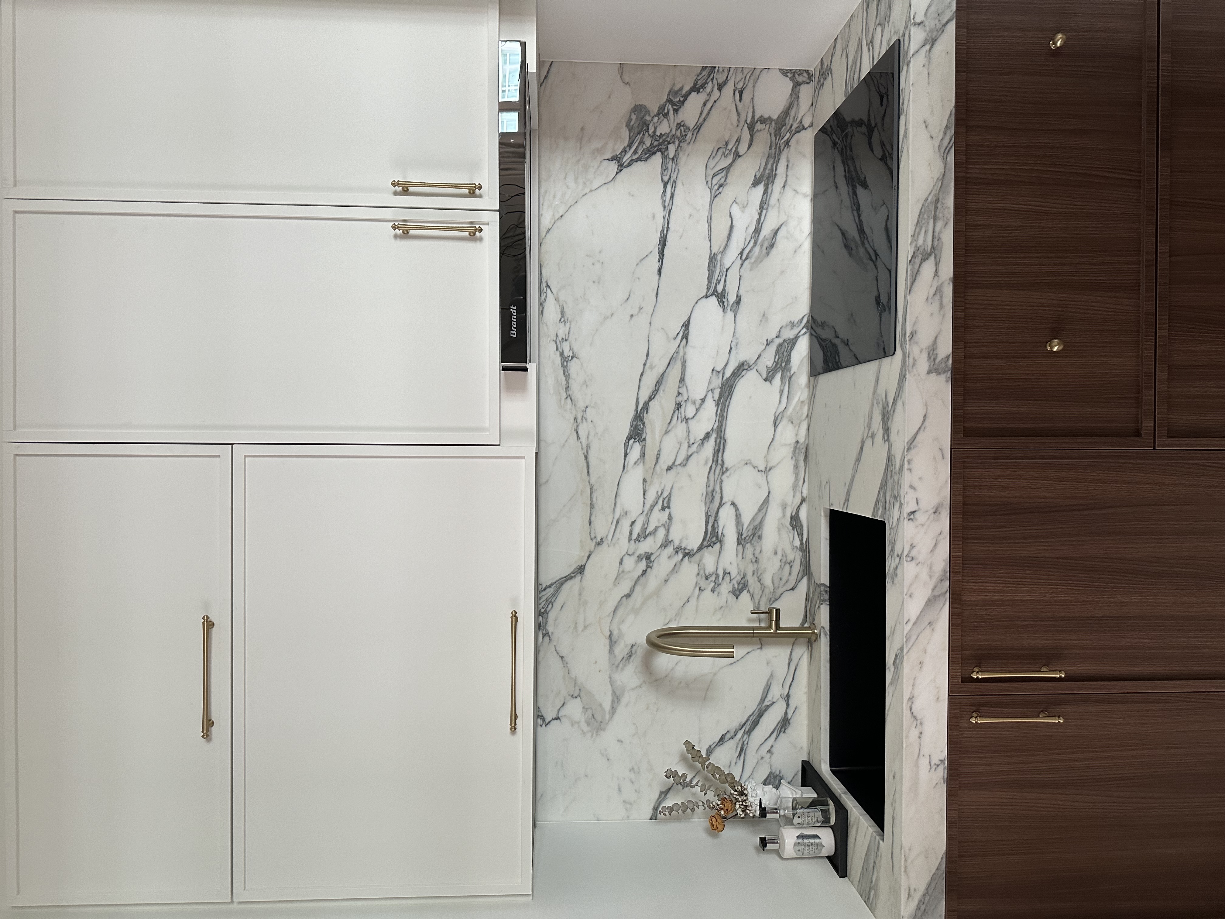 Our own unique blend of Parisian Chic & Urban NYC - White marble wall, modern bathroom, wooden cabinets, gold handles