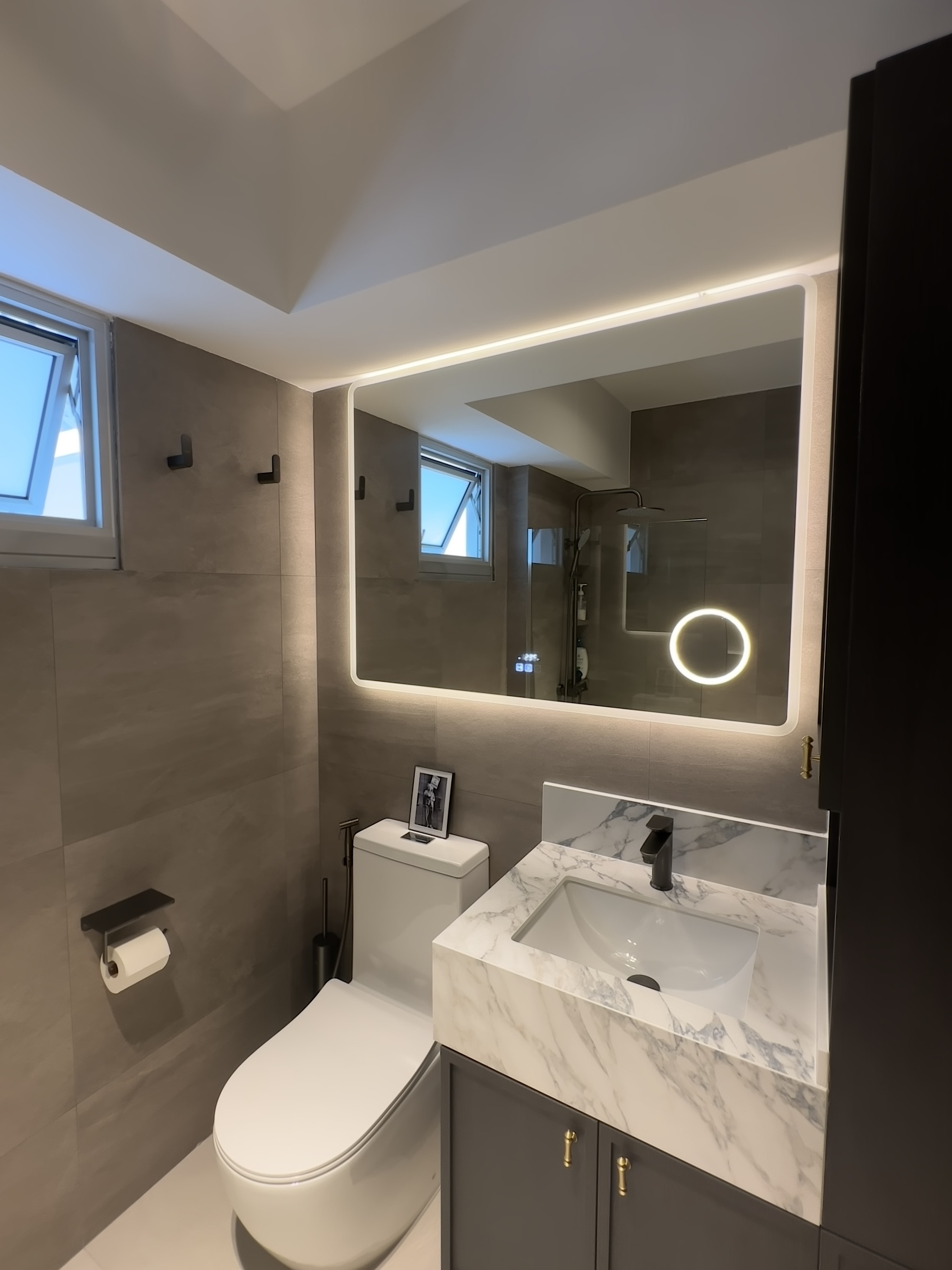 Our own unique blend of Parisian Chic & Urban NYC - Modern bathroom with sleek design, large mirror with integrated lighting