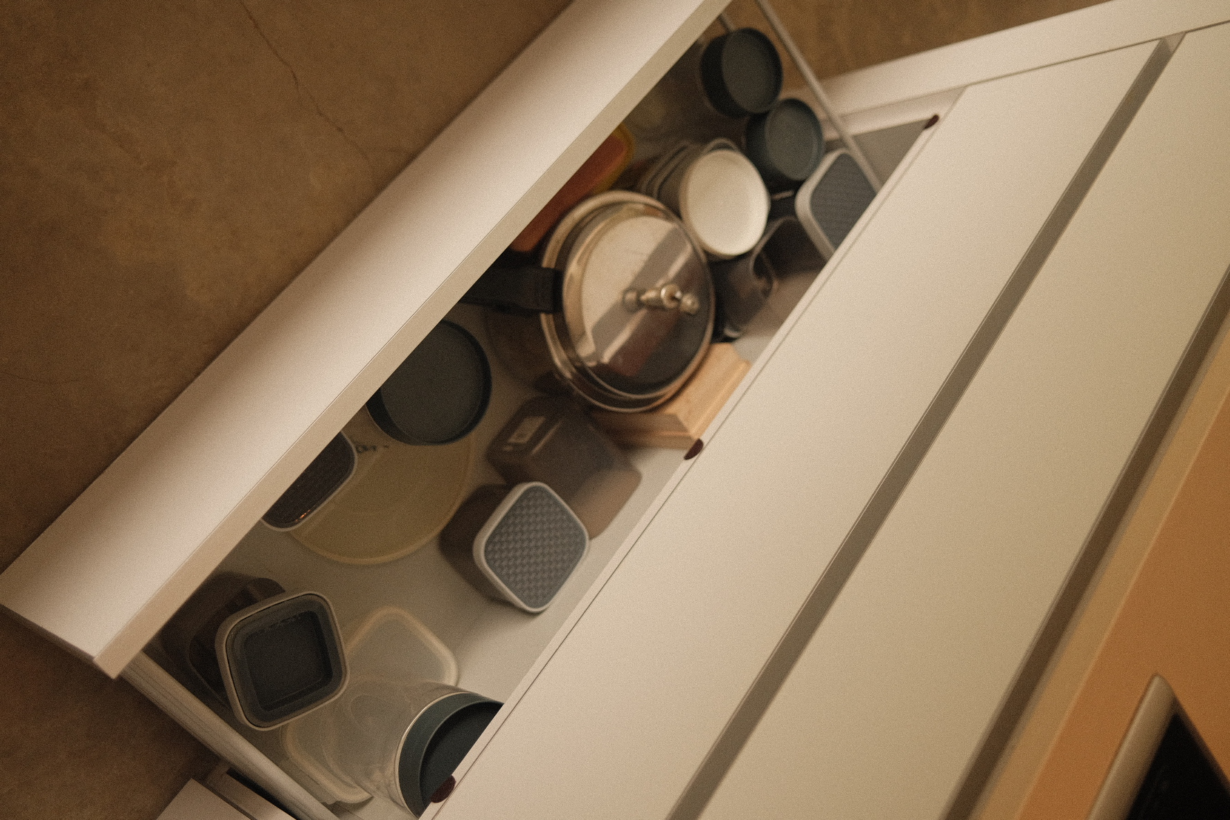 Kitchen Organisation around our Island Kitchen - White kitchen cabinet, open drawer, neatly organized utensils, various