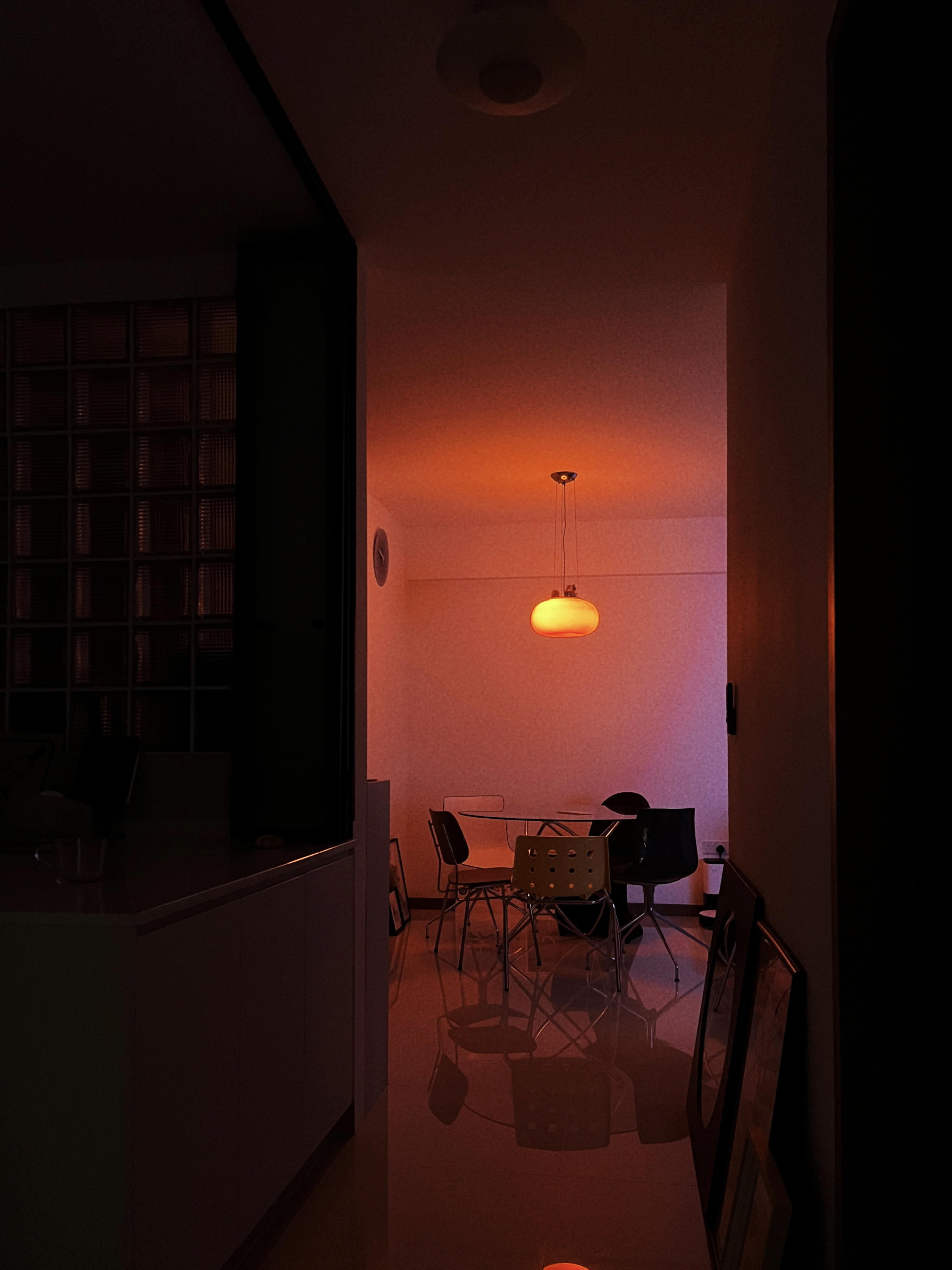 Come dine with beaconstrips: A space filled with mismatched chairs - Modern minimalist dining room, warm ambient lighting