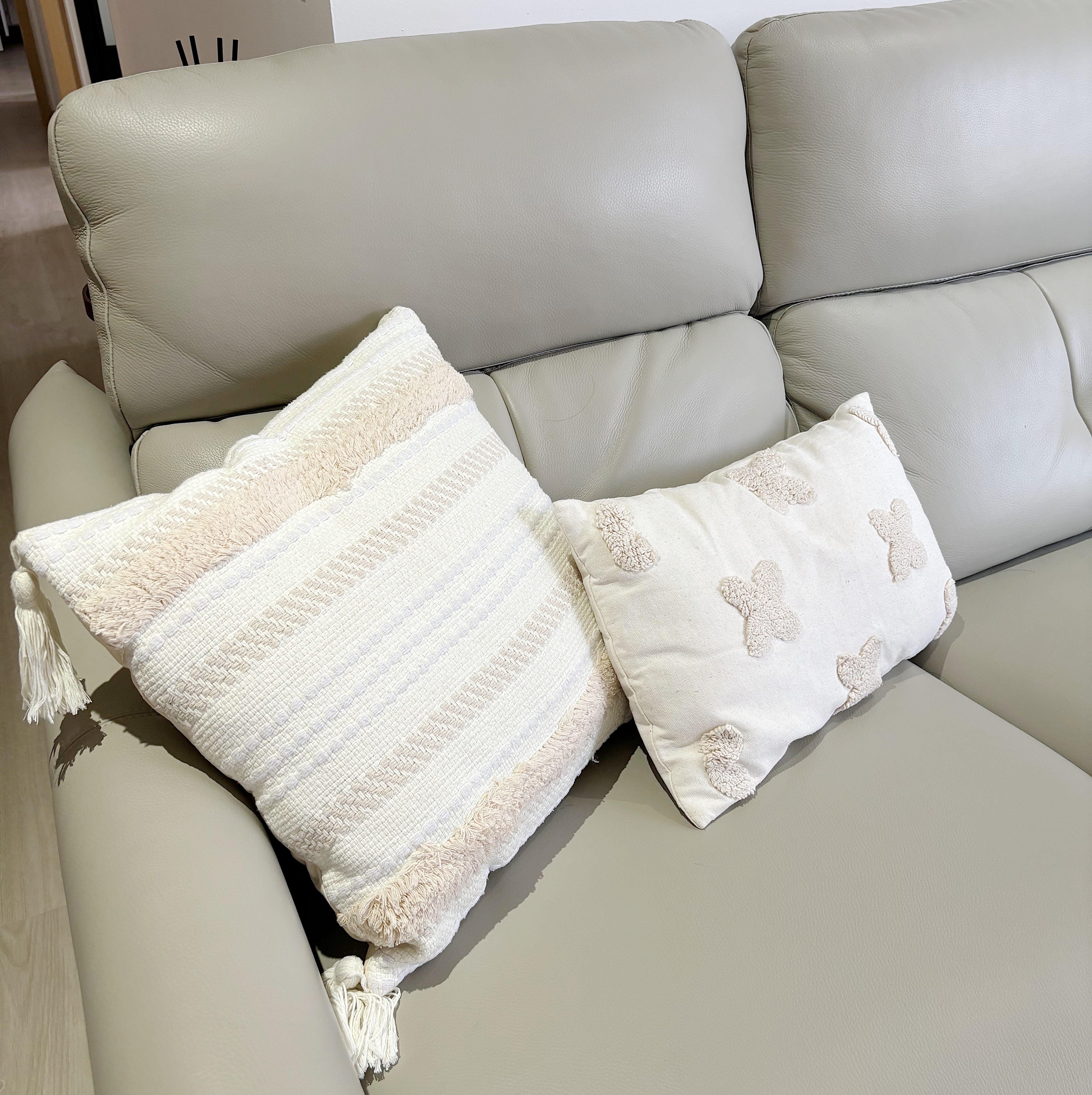 Ultimate Cozy Corner AKA the Sofa MVP - Leather sofa, beige upholstery, textured surface, cozy cushions, decorative pillows