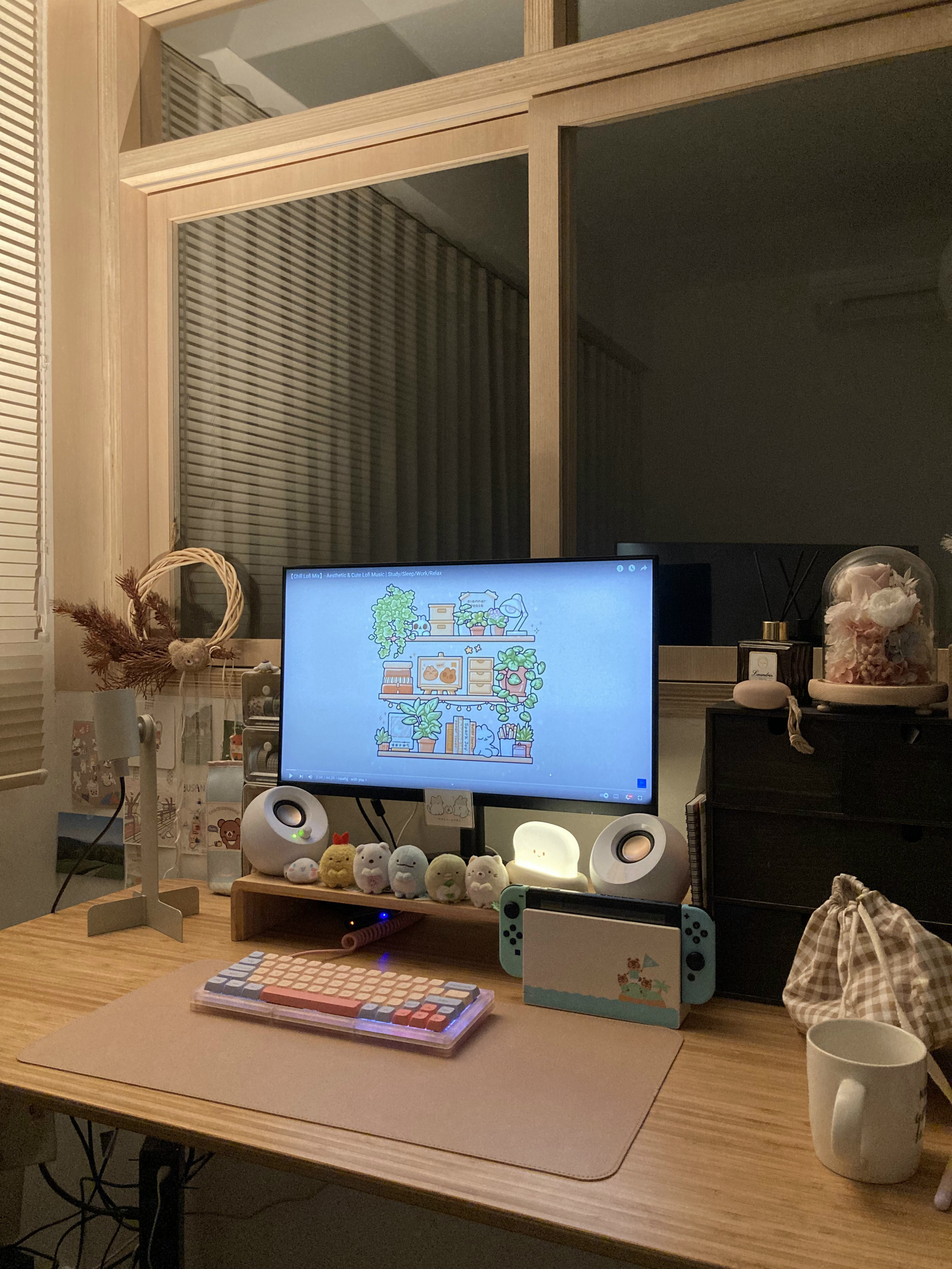 Creating a cosy corner with the things you love most - Wooden desk, computer monitor, colorful cartoon wallpaper, desk lamp