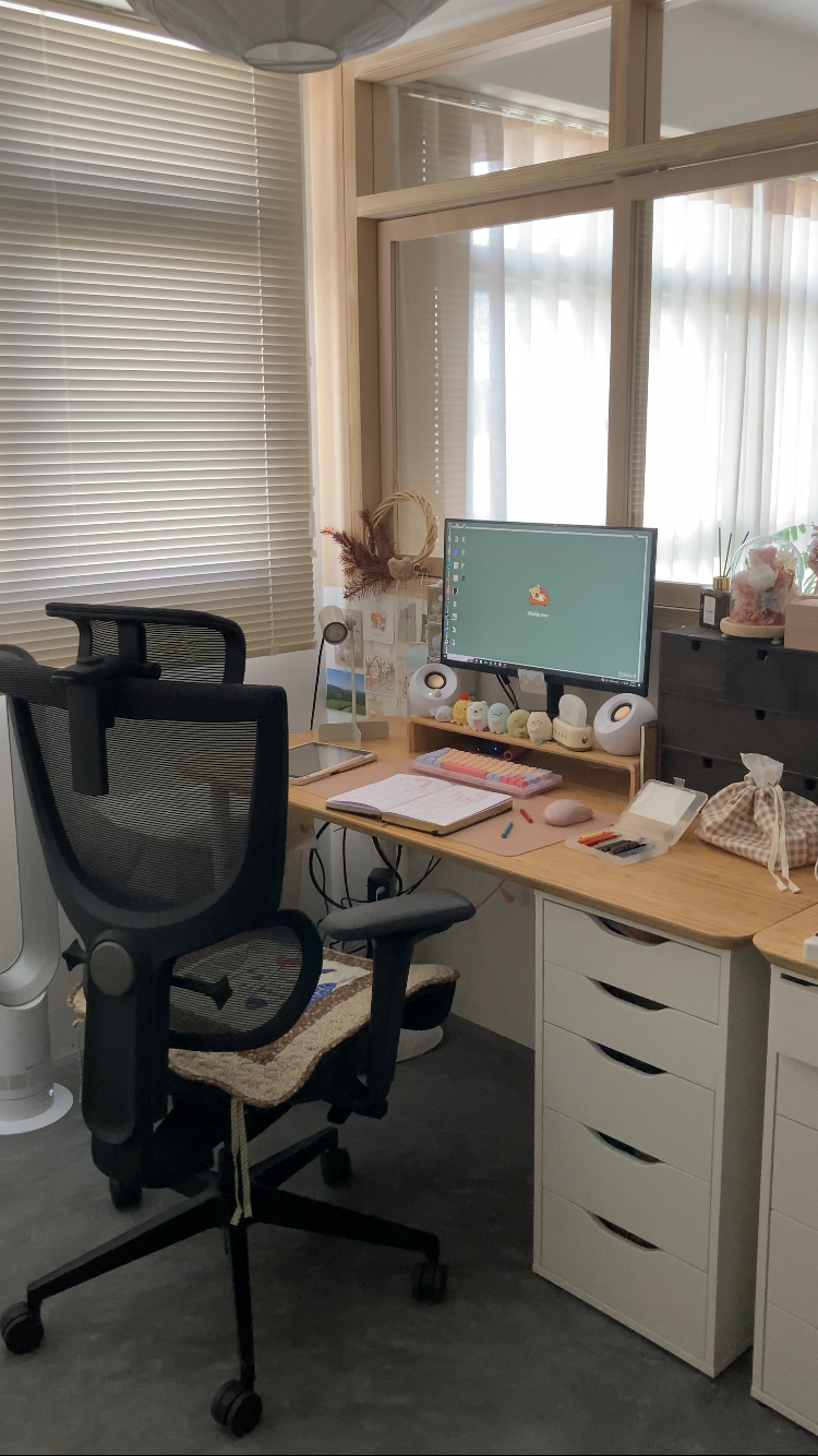 Creating a cosy corner with the things you love most - Wooden desk, black office chair, computer monitor, desktop computer