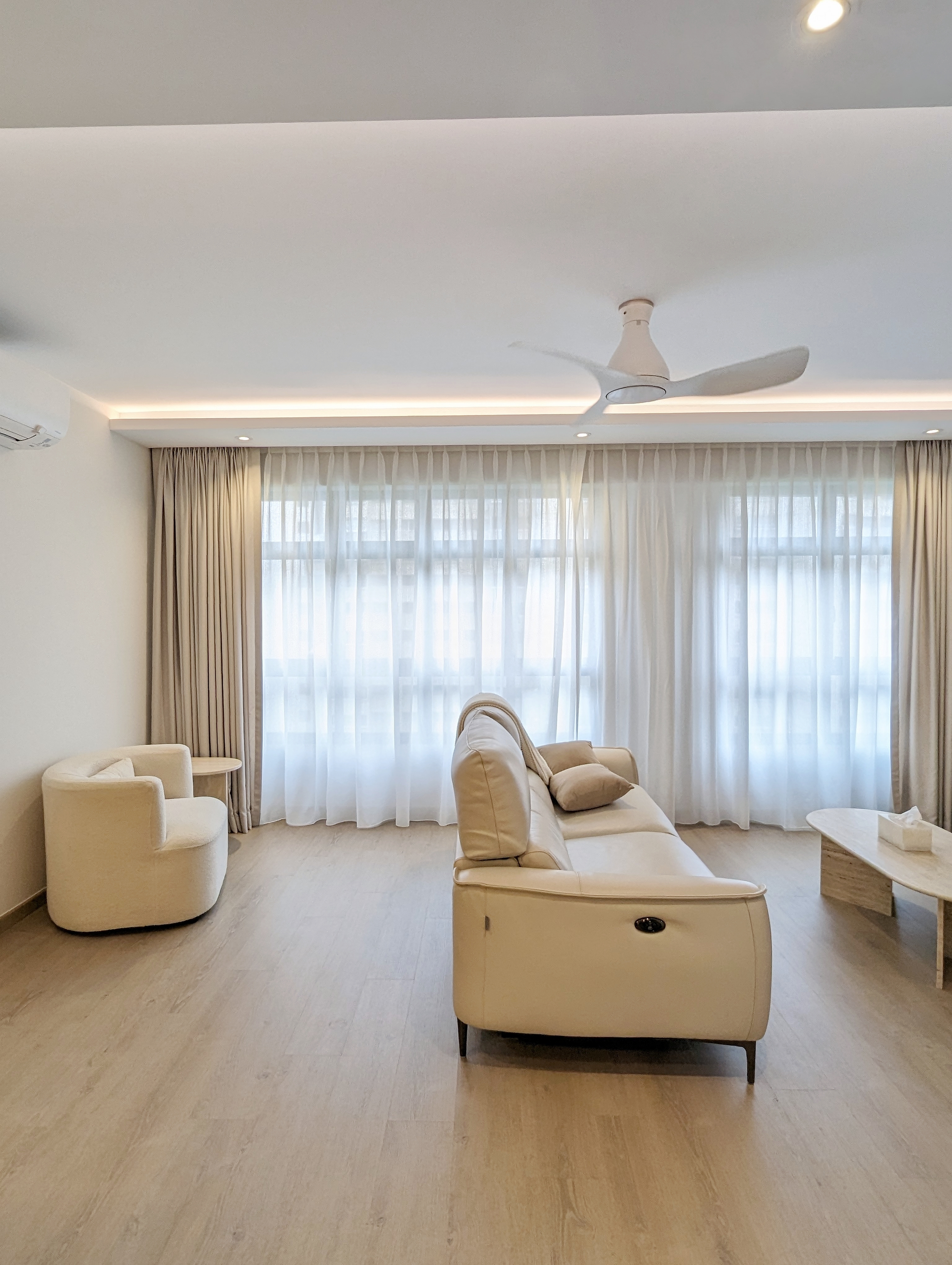 When function meets aesthetics  - Modern minimalist living room, neutral color palette, large windows, sheer curtains, light