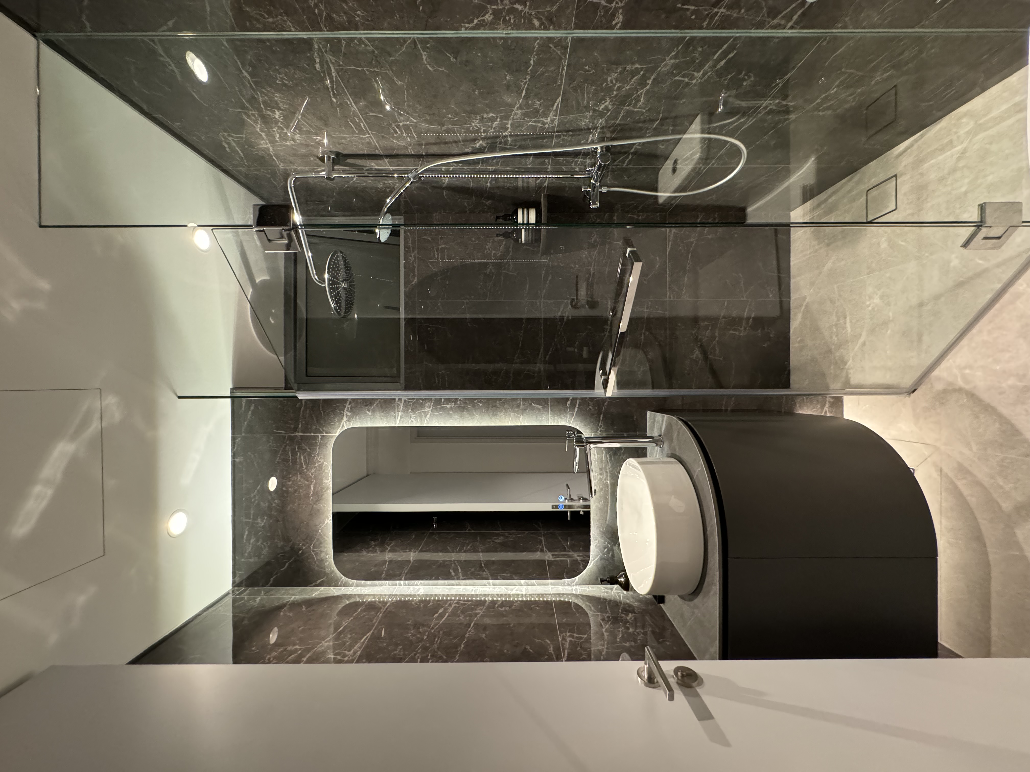Rumah Beacon, where each object tells a story. - Modern bathroom, sleek design, dark marble walls, glass shower enclosure