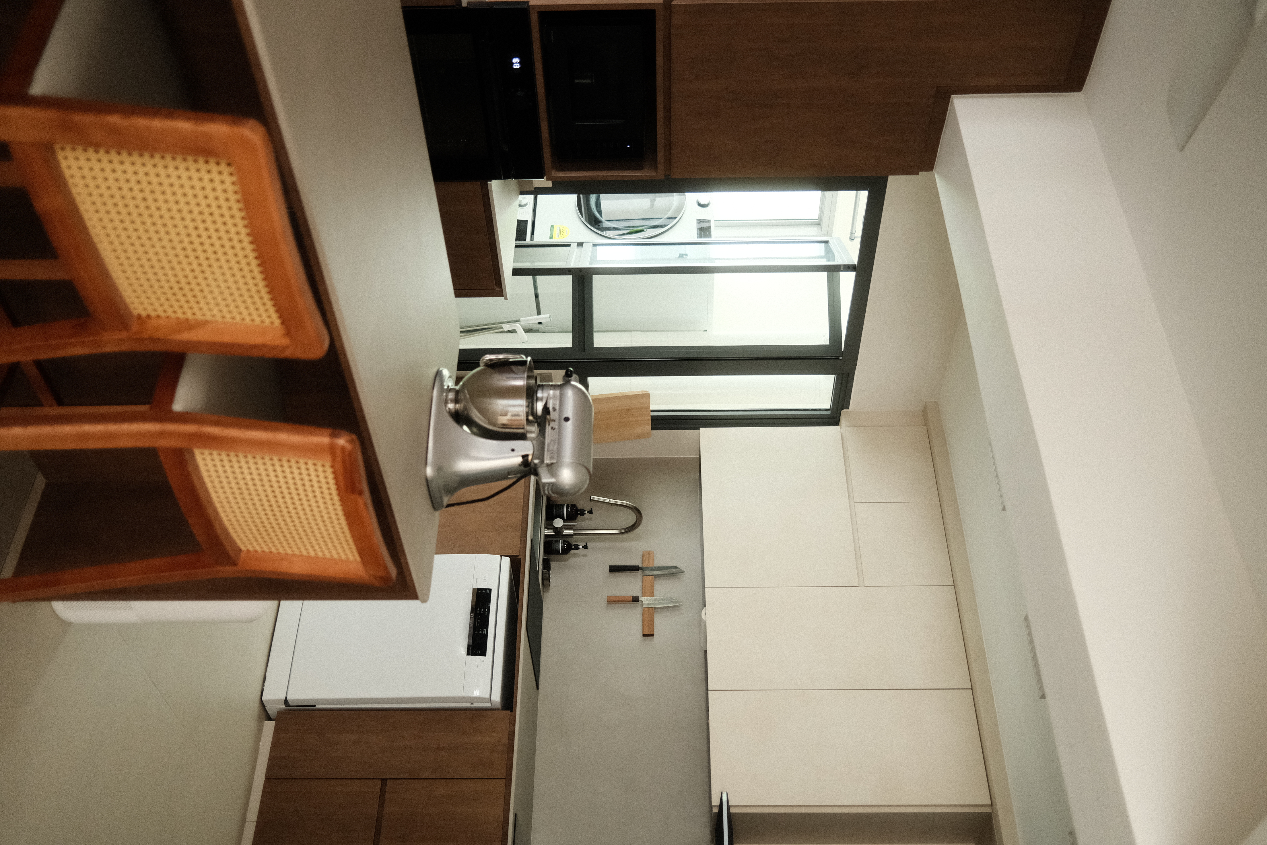 A warm and zen space (Japandi) - Wooden kitchen cabinets, modern appliances, stainless steel mixer, wooden cutting board