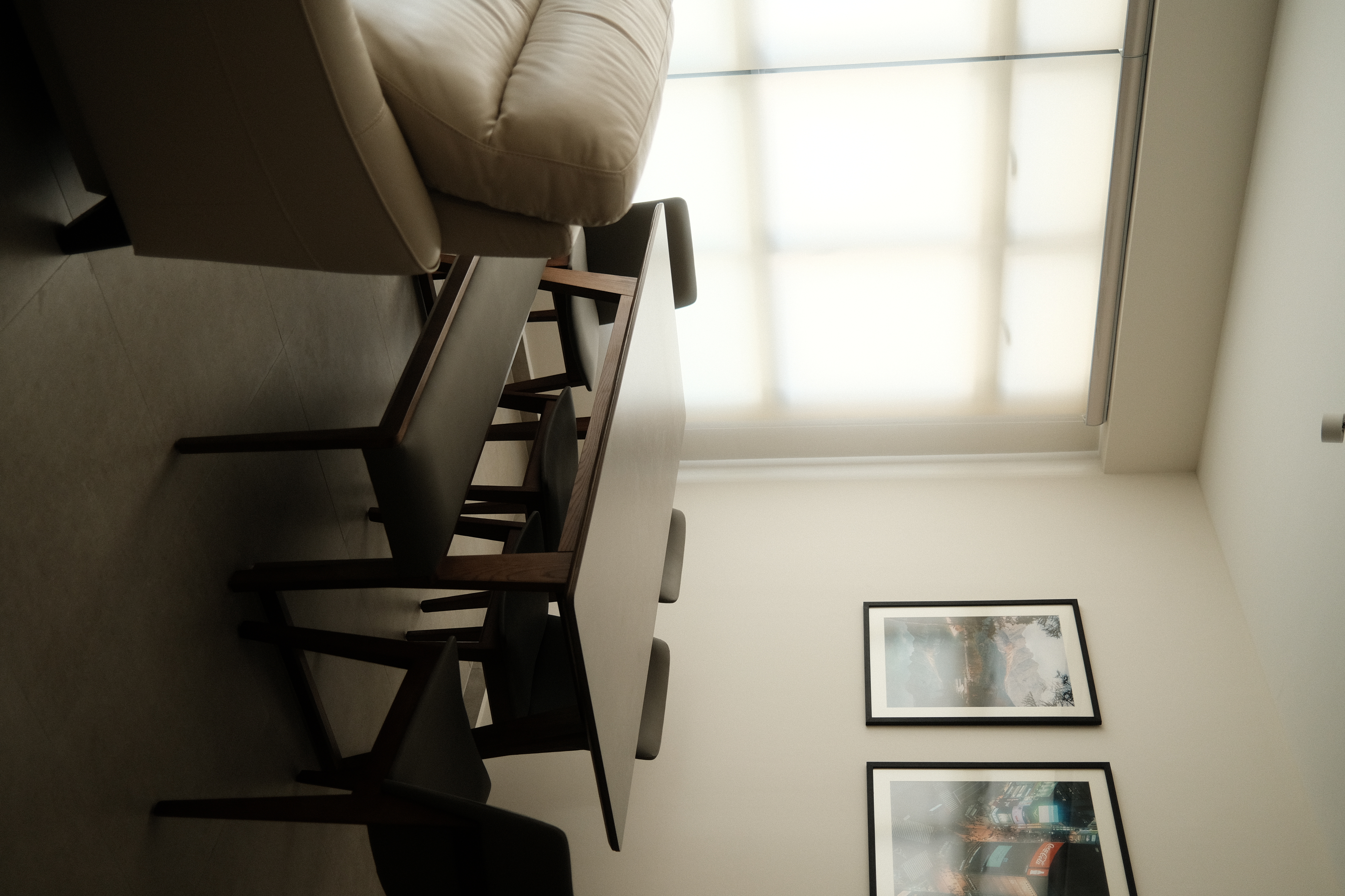 A warm and zen space (Japandi) - Modern minimalist interior, beige leather chair, wooden chair legs, floor-to-ceiling