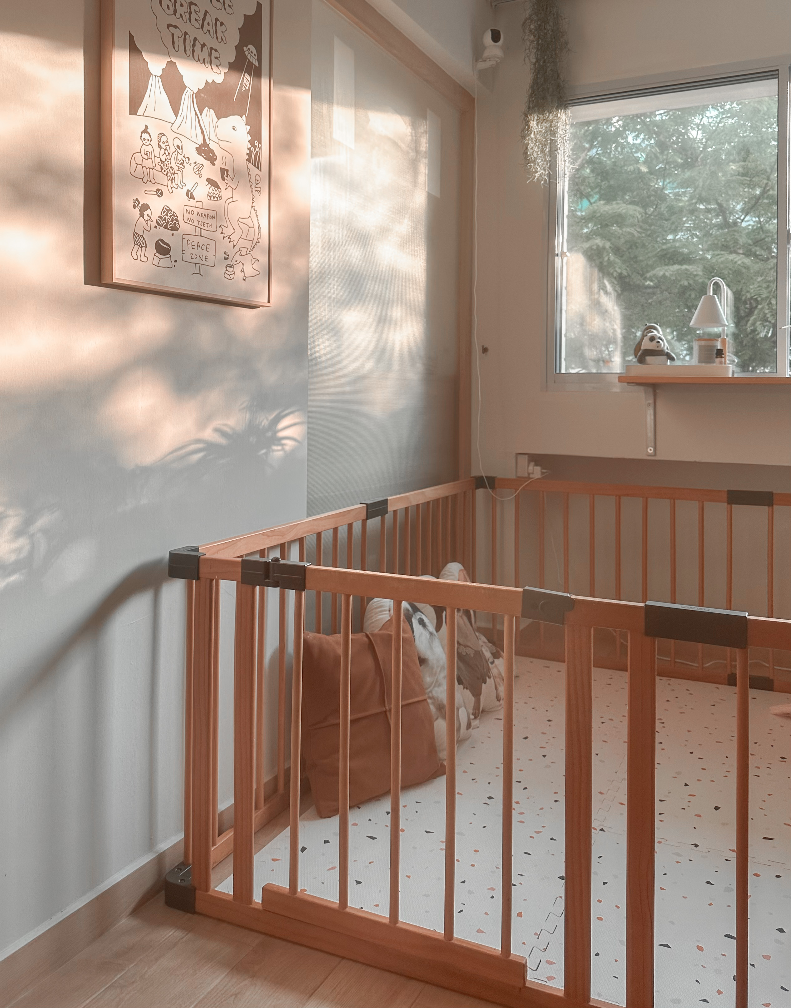 Reconfiguring the space for my toddler - Sunlight filtering through sheer curtains, soft shadows cast on the wall, wooden